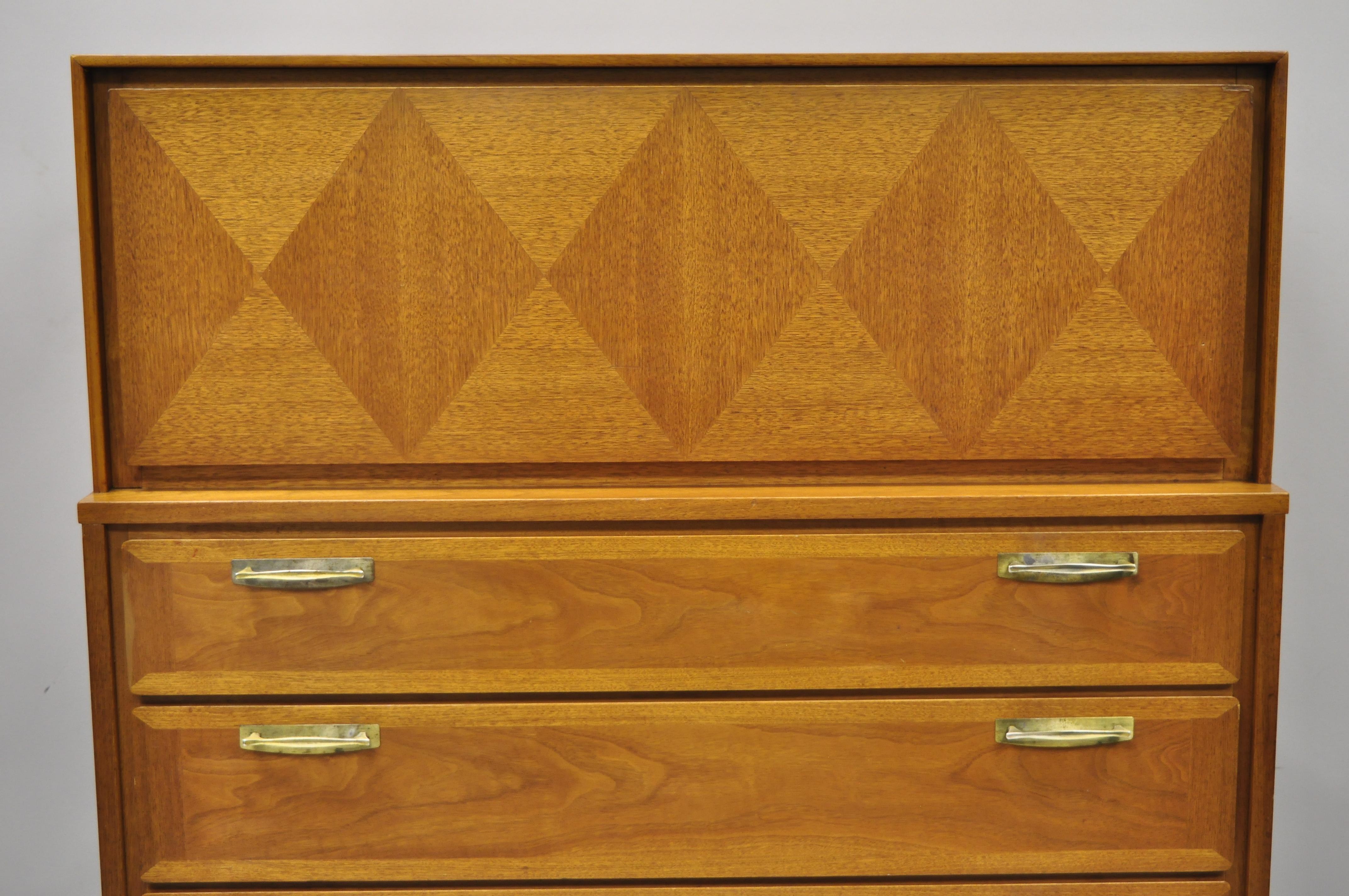 Vintage Mid-Century Modern diamond inlay walnut chest dresser by Red Lion. Item includes drop down lid, beautiful wood grain, 5 dovetailed drawers, tapered legs, solid brass hardware, nice inlay, banded details, circa mid-20th century. Measurements: