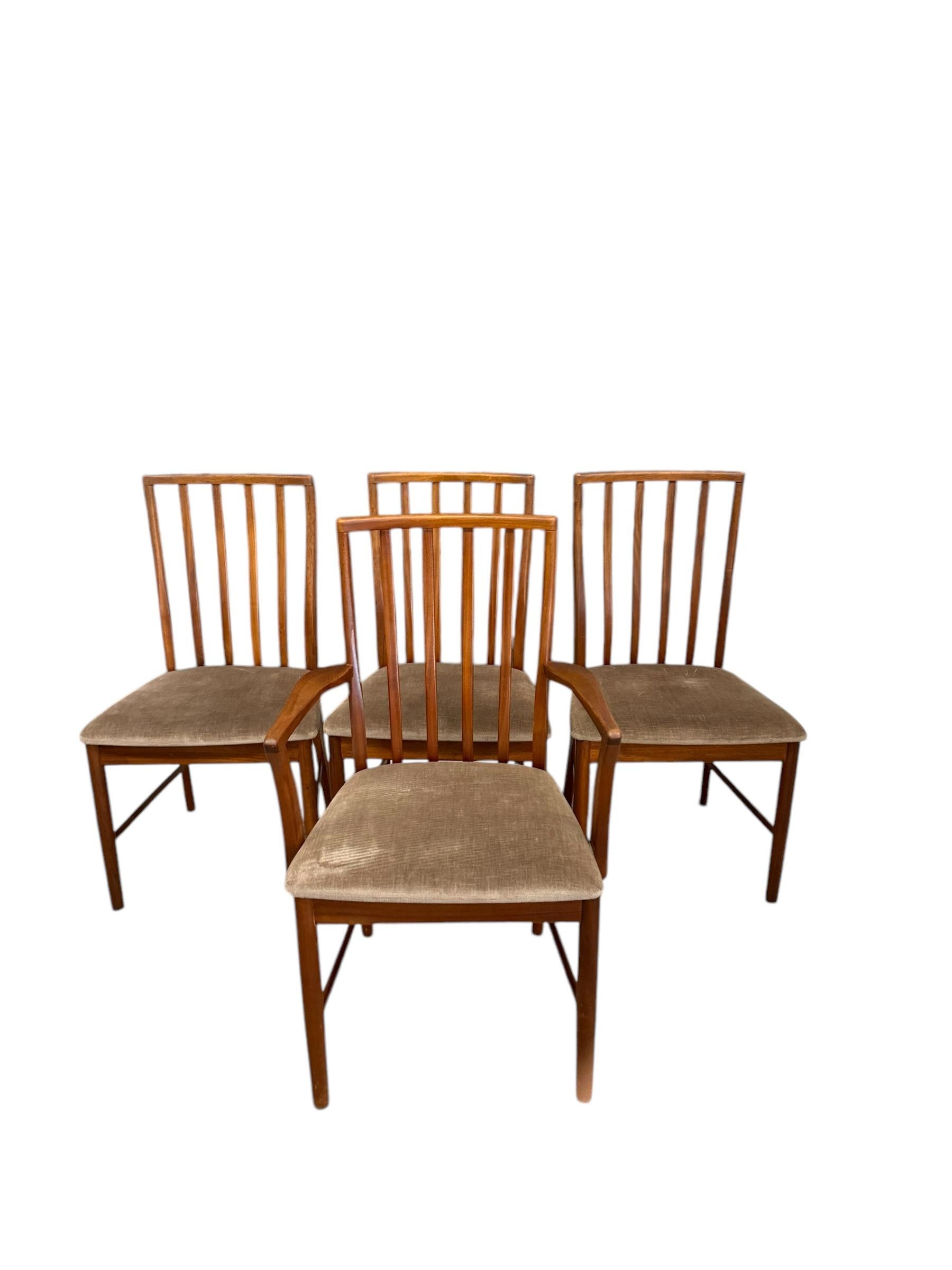 Beautiful set of four solid wood mid-century dining chairs by AH McIntosh of Scotland circa early 1970's. These chairs feature quality craftsmanship and mid-century style, with nicely padded seats. Fabric is in good shape with no tears. Frames are