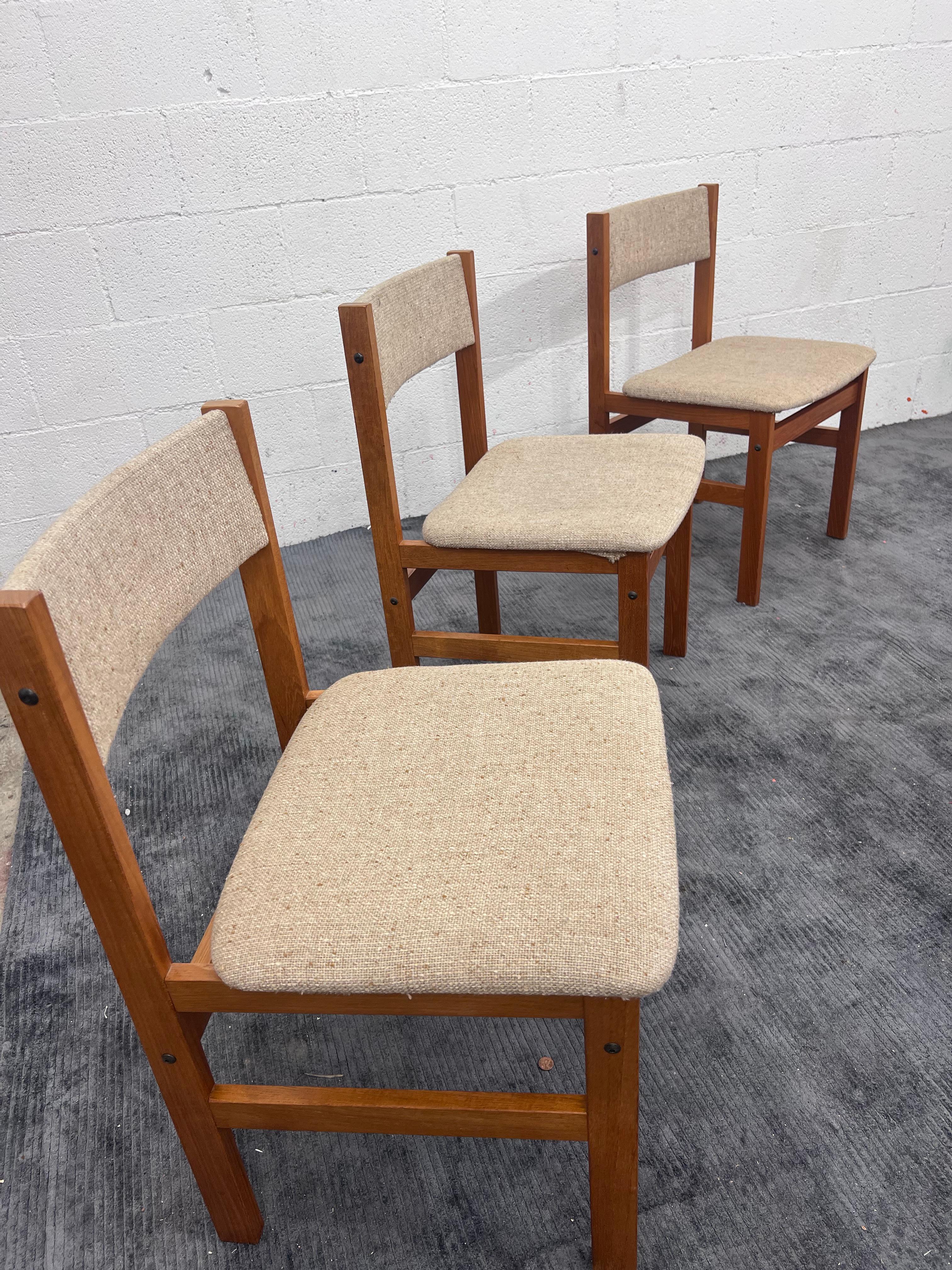 A set of 4 modular side chairs built in Denmark in the 1970s. Constructed in solid teak. 
