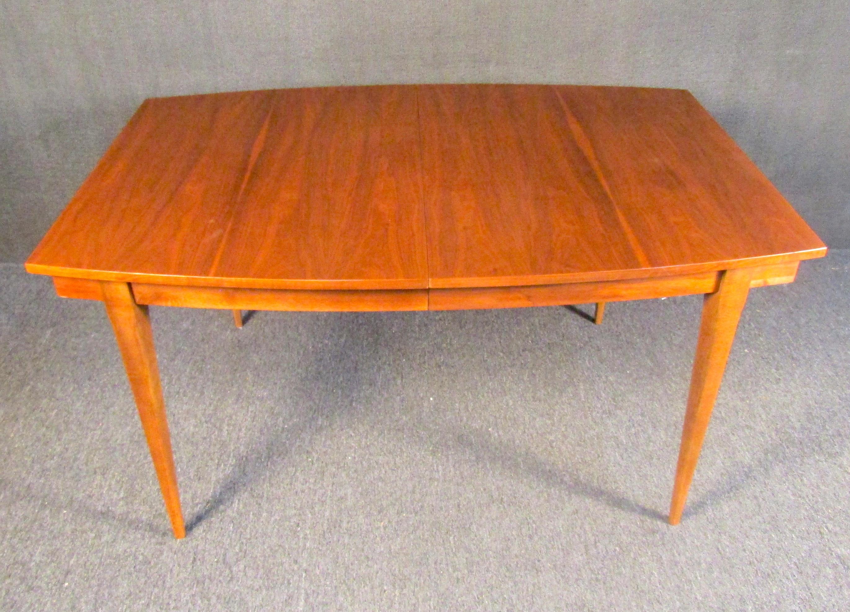 Vintage Mid-Century Modern dining room table, combining rich woodgrain with a sleek angular design. Please confirm item location with seller (NY/NJ).