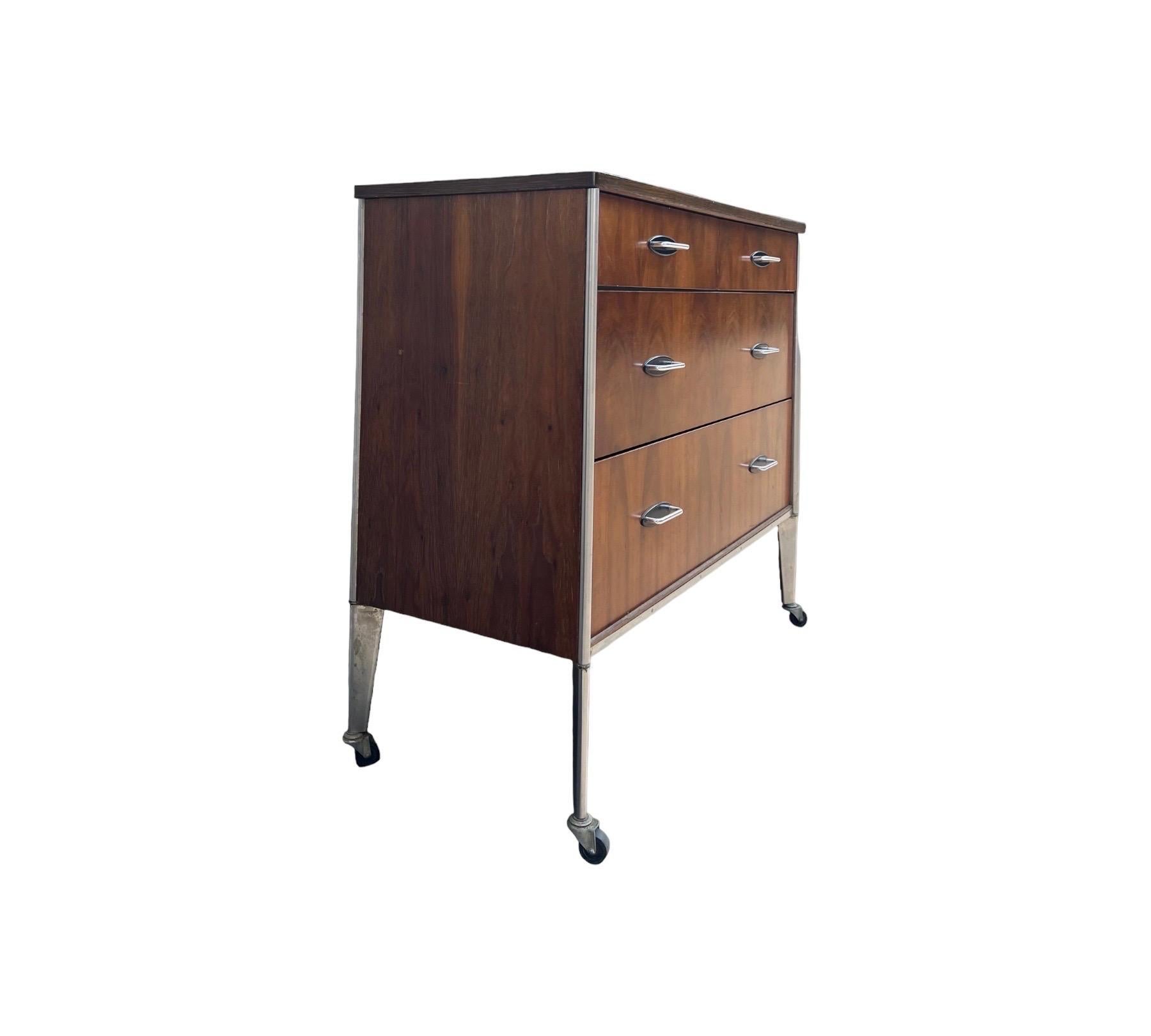 Vintage Mid Century Modern Dresser By Raymond Loewy For Hill Rom Walnut Casters  In Good Condition For Sale In Seattle, WA