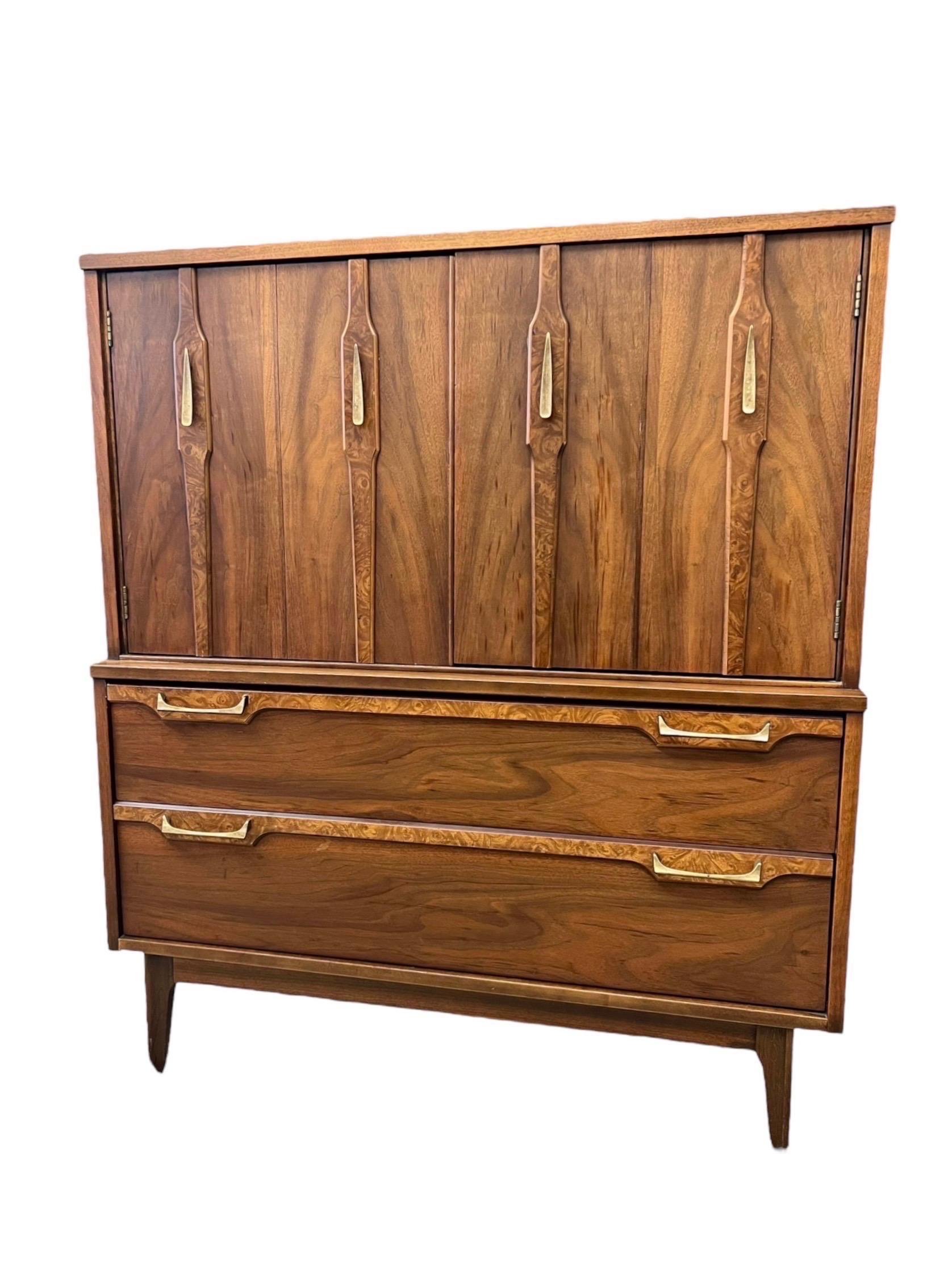 This MCM Dresser Set Features Contrasting Wood and Burl Veneer Accents , Solid Brass Hardware and a Gorgeous Wood Grain. The Dressers and End Tables are Structurally Sound and Smooth Sliding Drawers.

Dimensions. Tallboy. 40 W ; 18 D ; 47 H
        