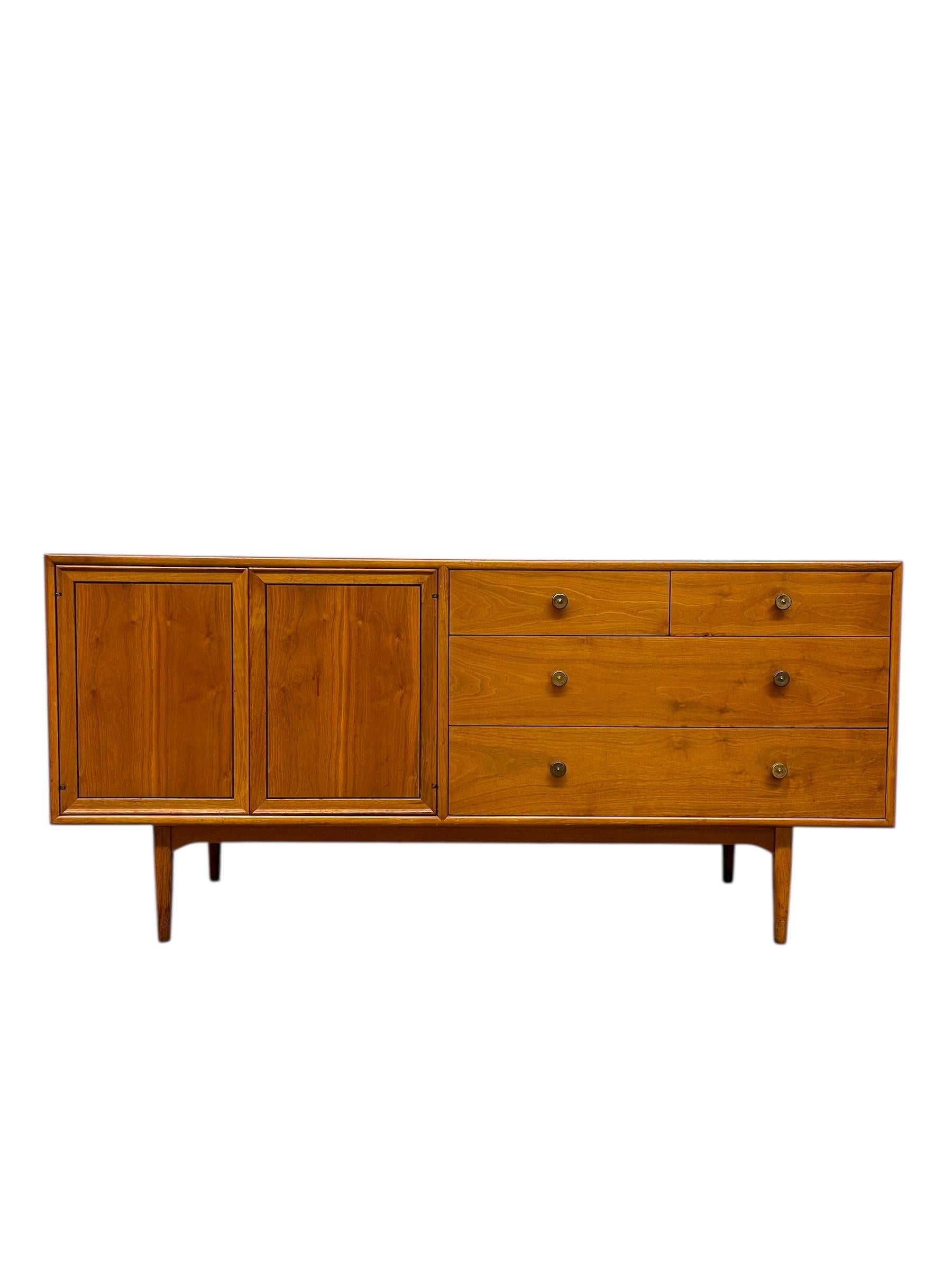 This vintage Drexel Declaration dresser or credenza exemplifies the timeless craftsmanship and clean-lined design of mid-century modern furniture. Designed and produced by Drexel in the 1960s, the piece is constructed of solid walnut with a warm,