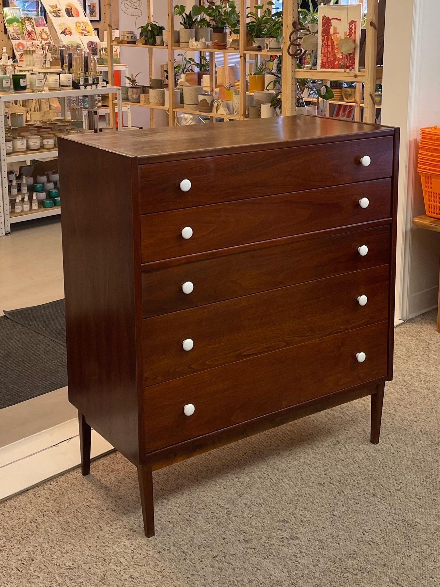 This Dresser Features 5 dovetailed drawers on tapered legs with original white toned hardware. We believed this to be a Drexel piece due to construction, design and overall feel. Buyer to Verify. Credenza is available with matching style through