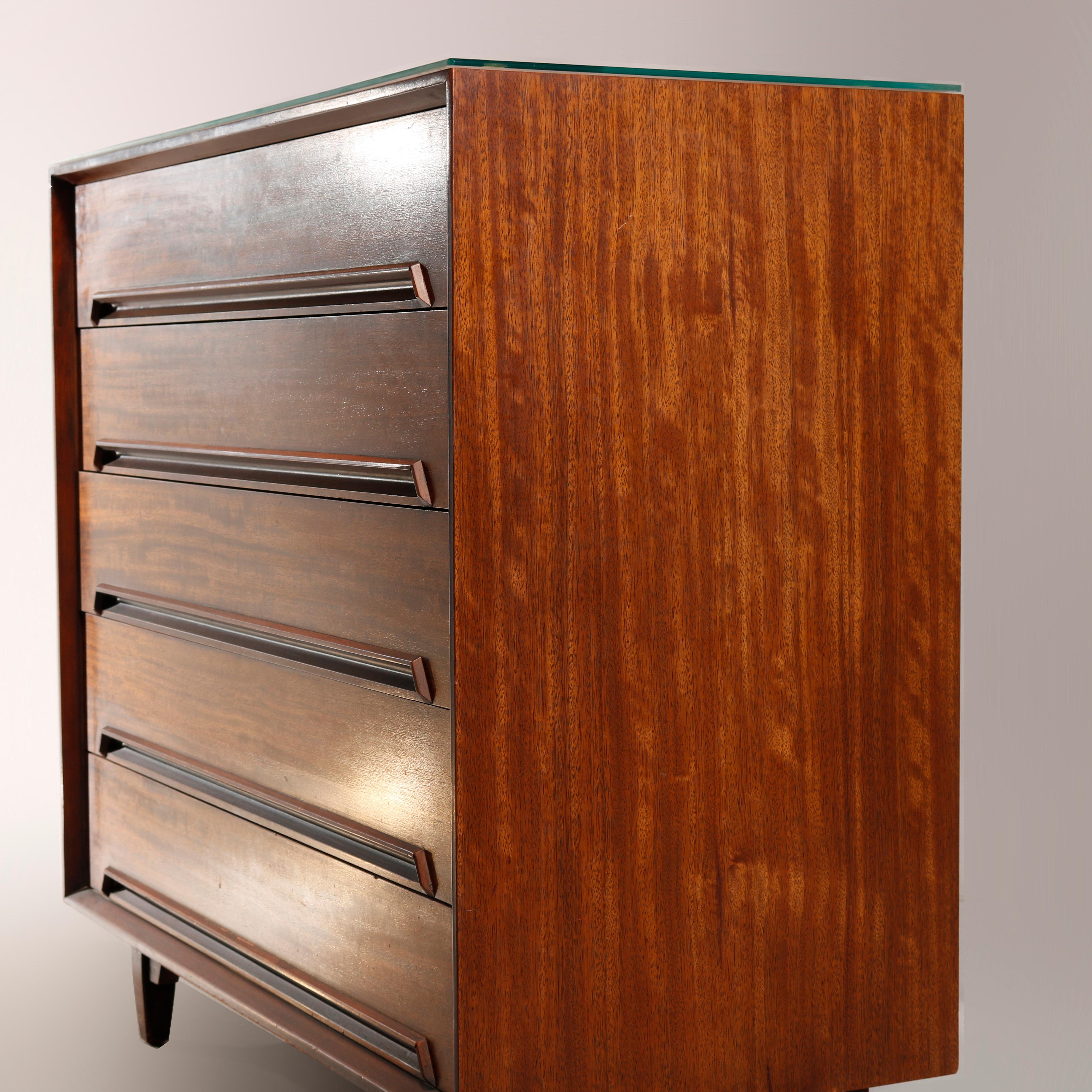 A Mid-Century Modern chest of drawers by Drexel of the Perspective line offers walnut construction with five stacked drawers, maker label on drawer interior as photographed, 20th century

Measures: 39.25