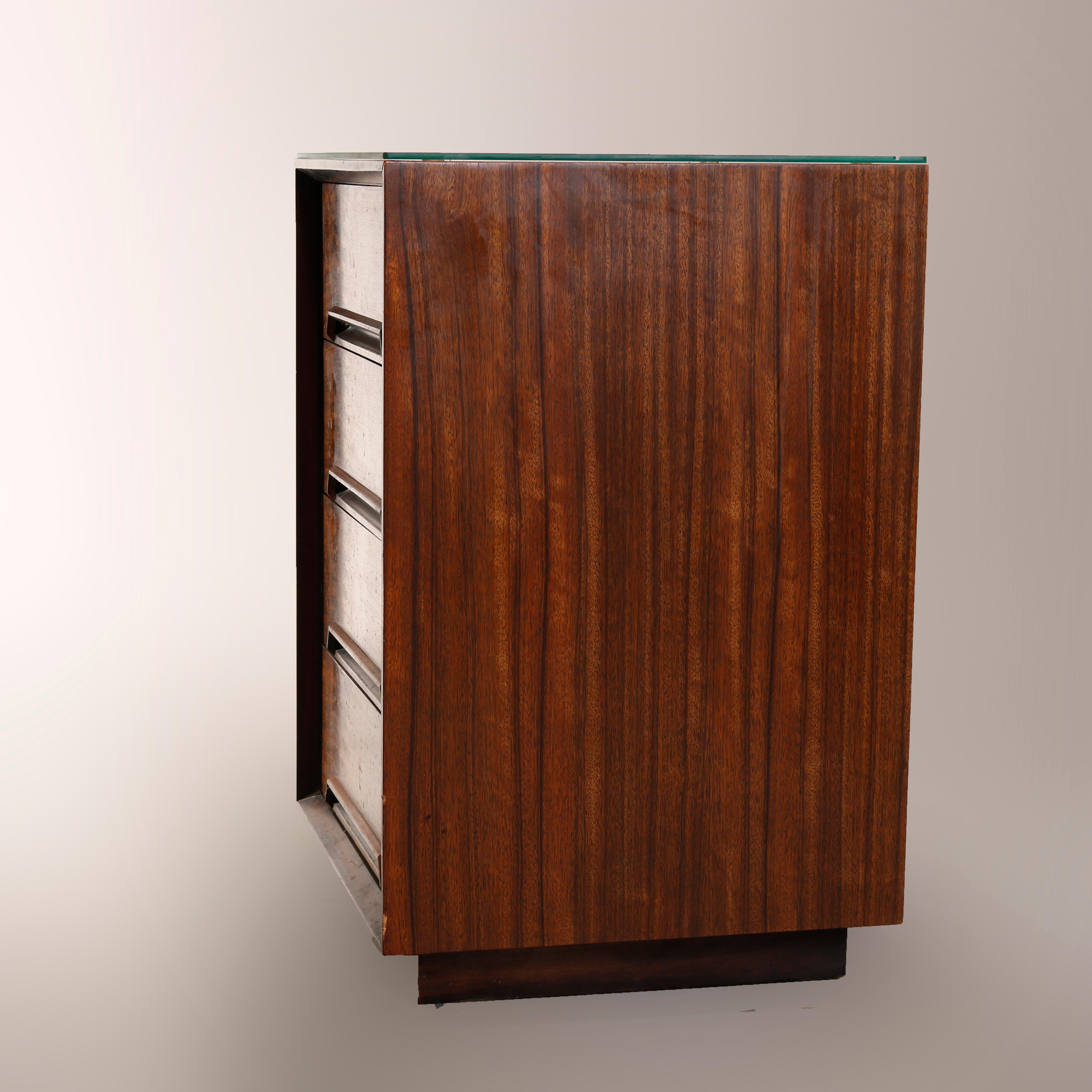 A Mid-Century Modern side cabinet by Drexel of the Perspective line offers walnut construction in tower form with three drawers, maker label on drawer interior as photographed, 20th century

Measures: 30.5