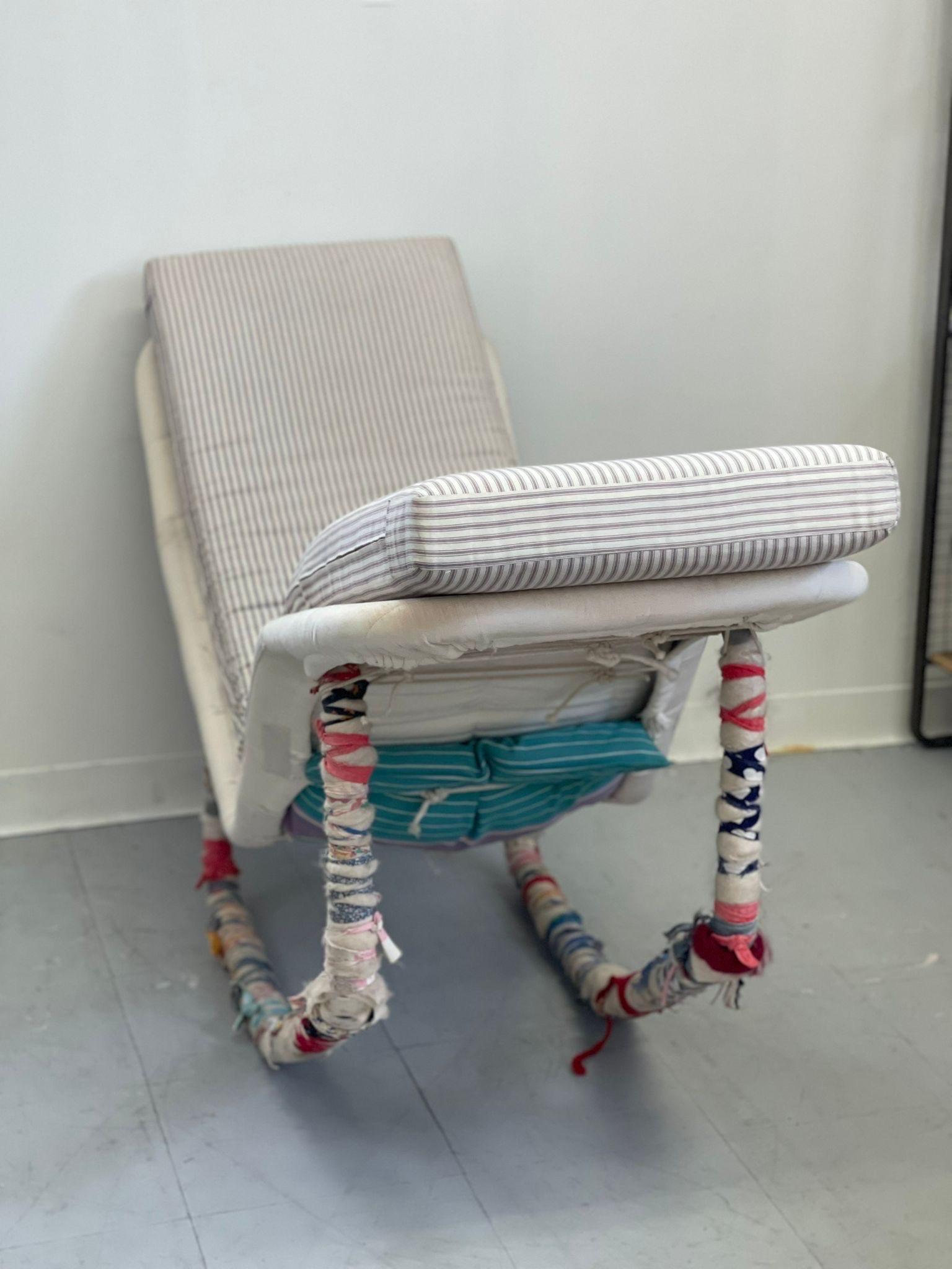 Edgar Bartolucci Rocking Chair Wrapped in Cloth by a Separate Artist. The Striped Padding is Removable. Features a weight on one End to Assist with Racking. No Maker’s Mark. Vintage Condition Consistent with Age as Pictured.

Dimensions. 60 W ; 20 D