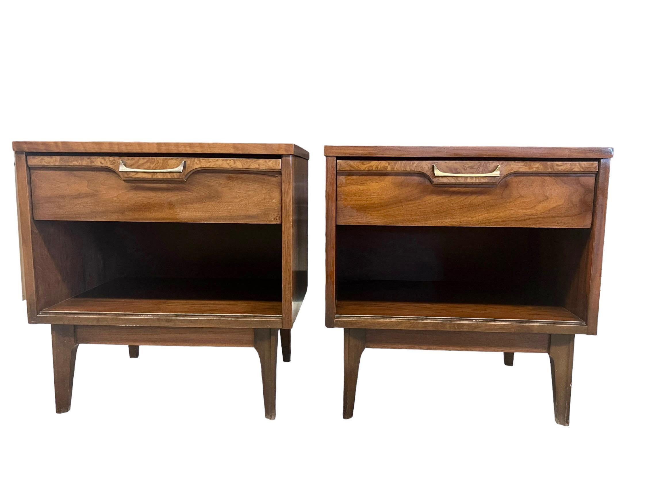 A Pair of Century Modern Walnut Single Drawer Night Stands with Brass Drawer Pulls and a Lower Compartment and Burl Accents 

Dimensions. 22 W ; 15 D; 23 H