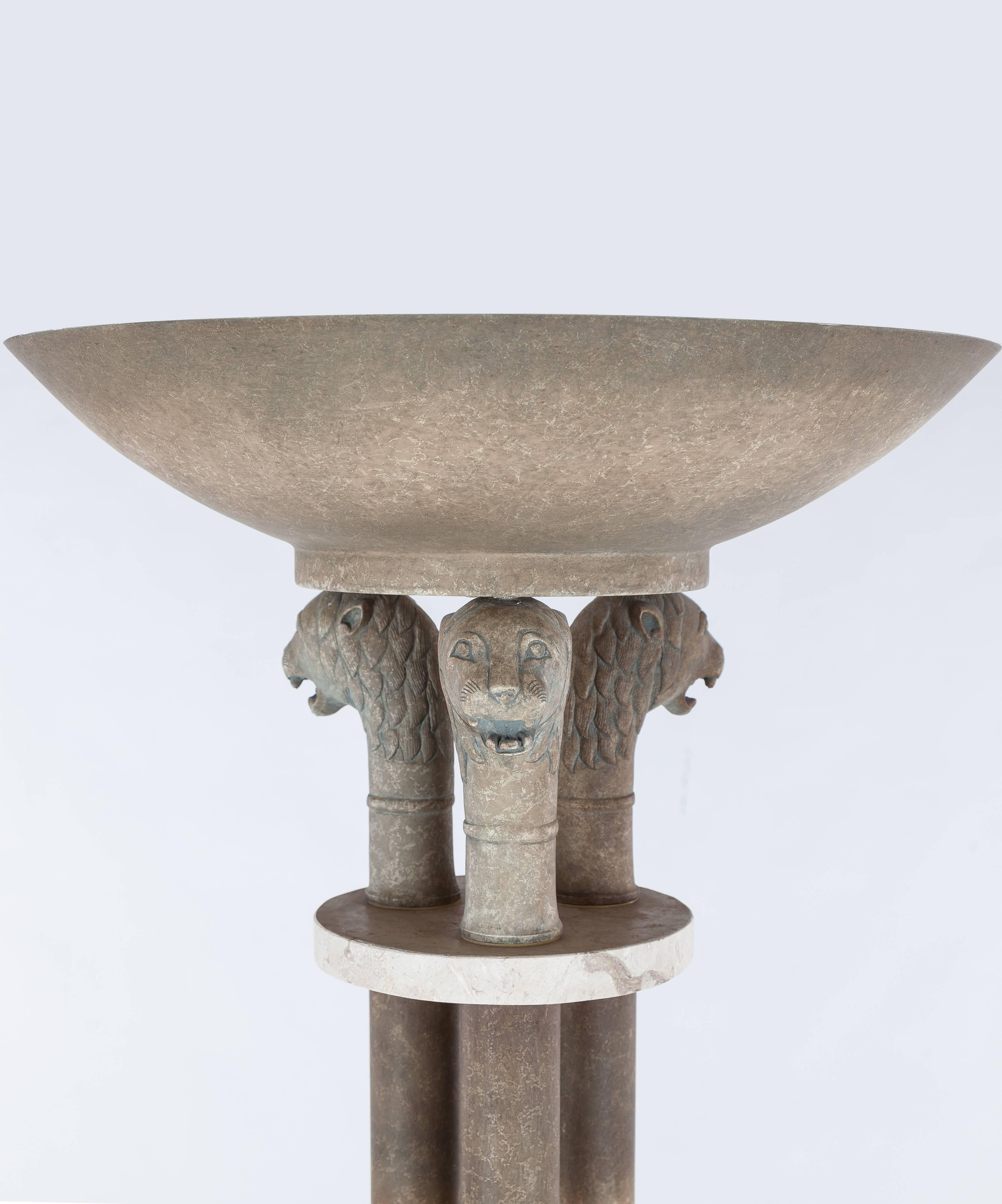 A vintage Mid-Century Modern torchiere lamp. It features a faux stone column-form with lion heads. The lamp measures approximately 20.75