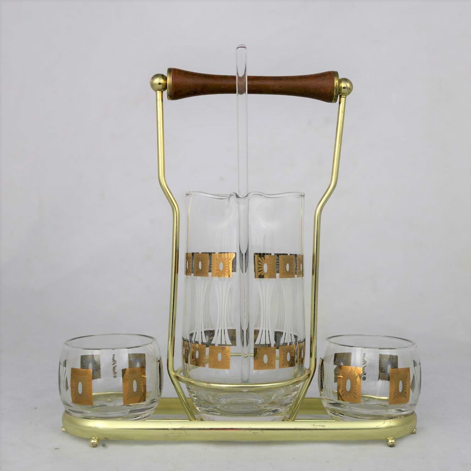 Handsome Mid-Century Modern cocktail caddy set by Fred Press in his sun block pattern. Comprised of a signed cocktail carafe with glass stirrer and two signed roly poly glasses in a brass plated carrier. They are all in fabulous vintage condition