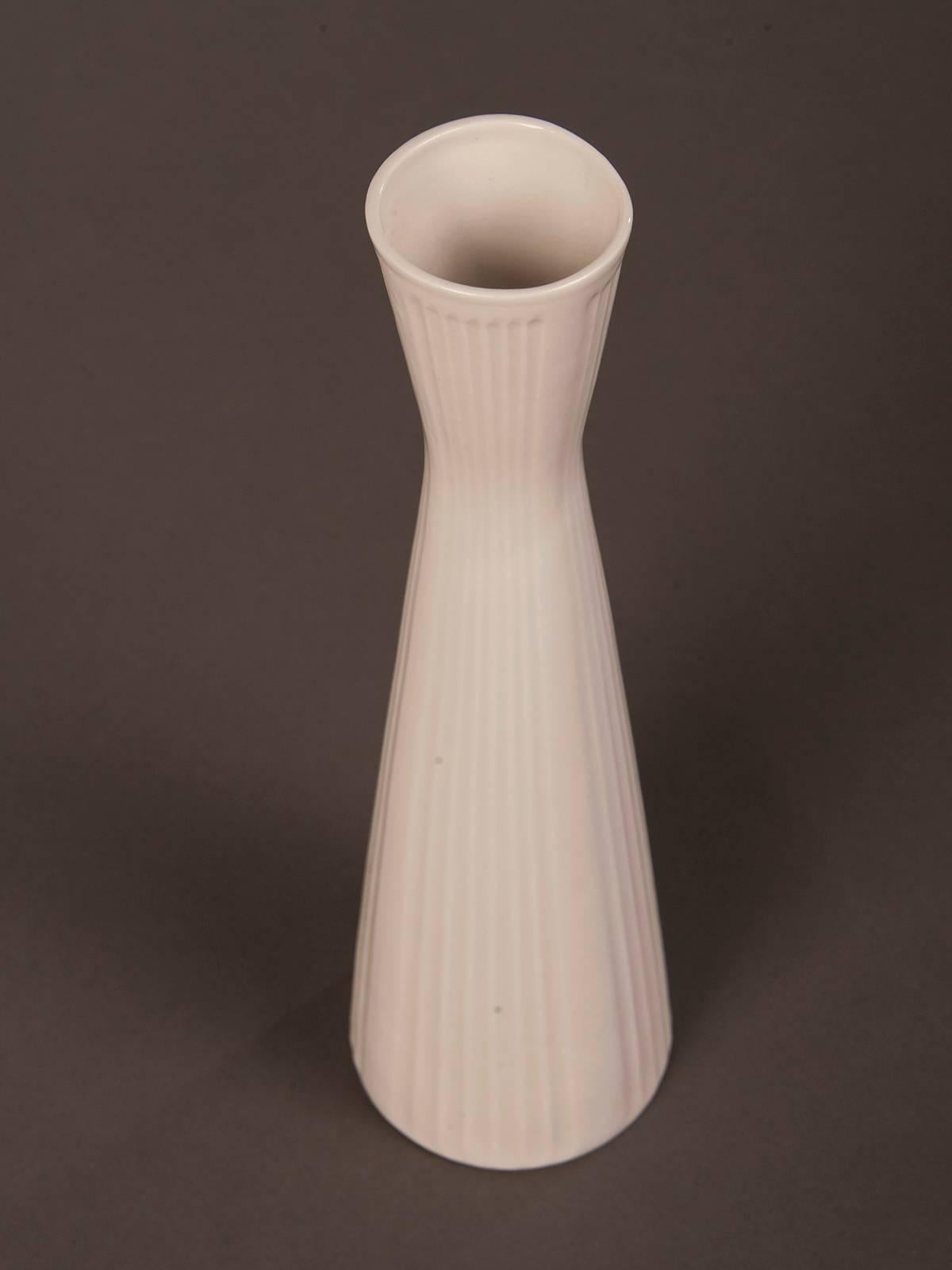 A tall Mid-Century Modern white porcelain vase with a tall flared shape from Germany, circa 1950 with the maker's stamp on the underside. This contemporary vase was manufactured by Schumann in Arzberg located in Bavaria in the southeast area of