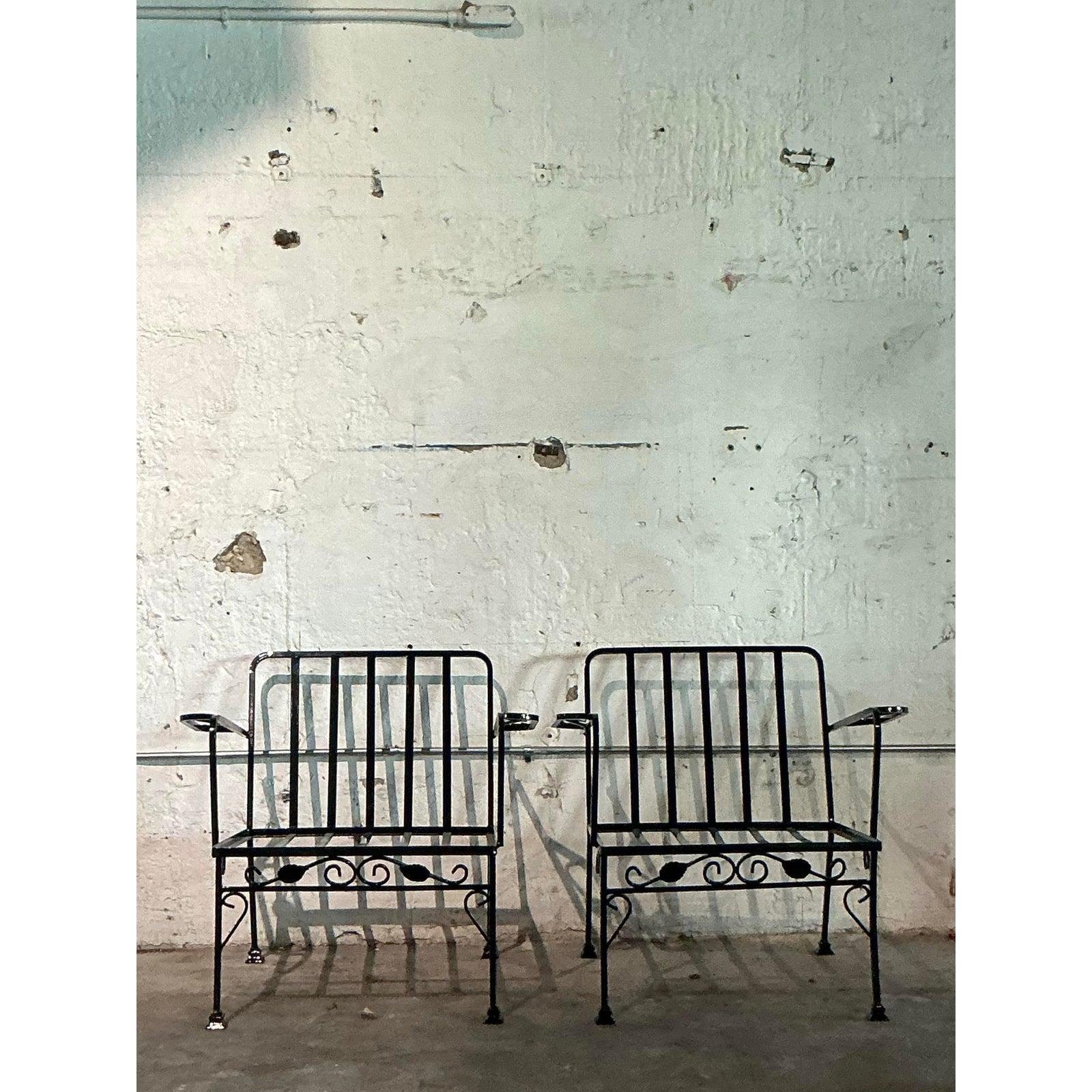 Cette paire de chaises longues vintage est une fusion parfaite entre les lignes modernes du milieu du siècle et l'élégance classique du jardin. Fabriquée de manière experte en fer forgé durable avec une finition noire élégante, chaque chaise