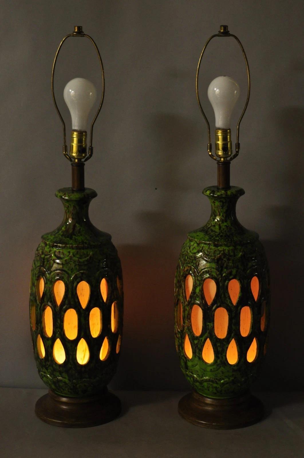 Vintage Mid Century Modern Green Lava Glazed Ceramic Pierced Fretwork Table Lamps w/ Interior Lights - a Pair. Circa Mid 20th Century. Measurements: 32.5