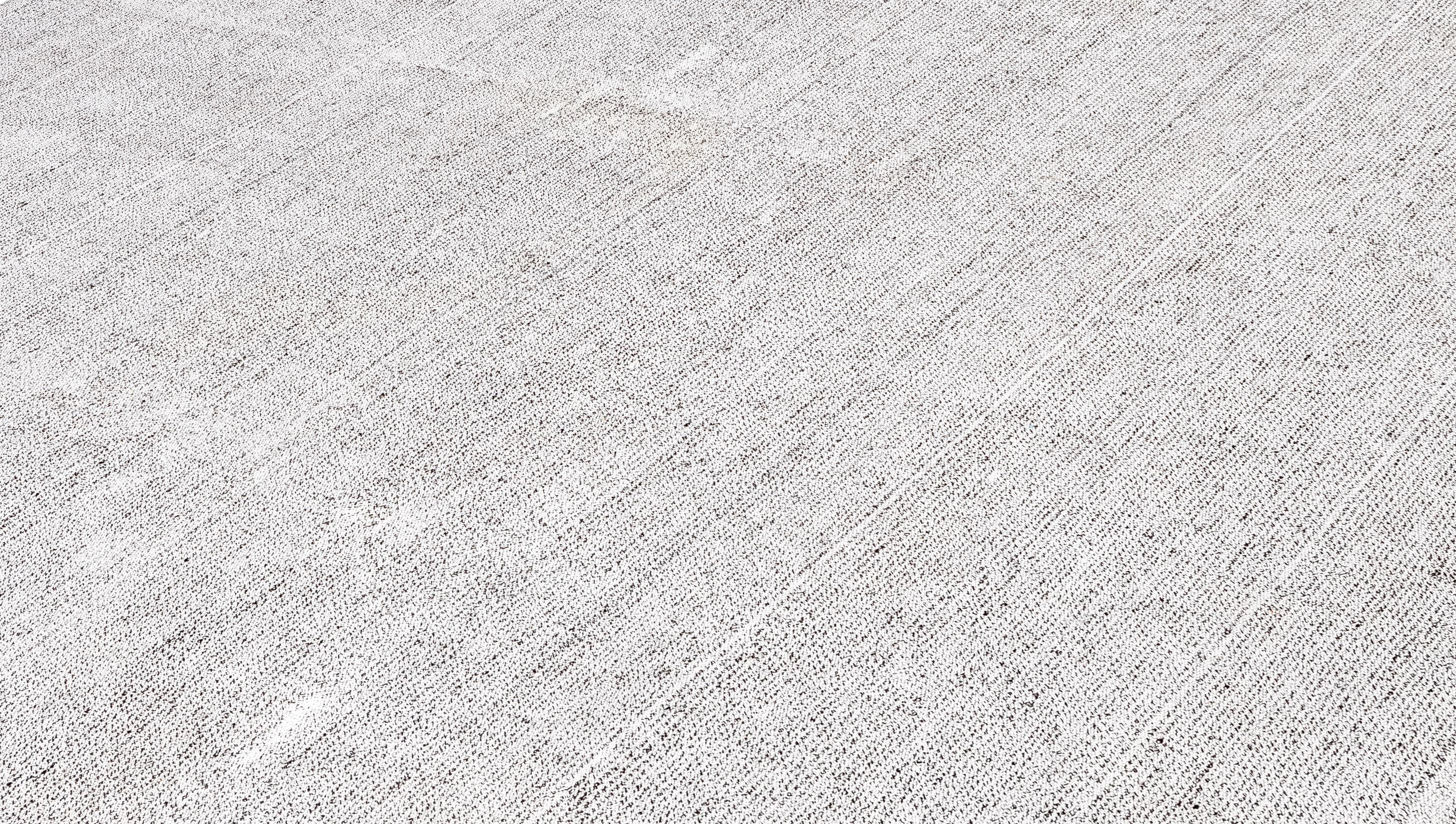 This Mid-Century Modern flatweave rug is handwoven in Iran using a refined blend of handspun wool and linen, all dyed with 100% natural, organic dyes. Reflecting the minimalist sophistication of mid-20th-century design, the rug balances subtle