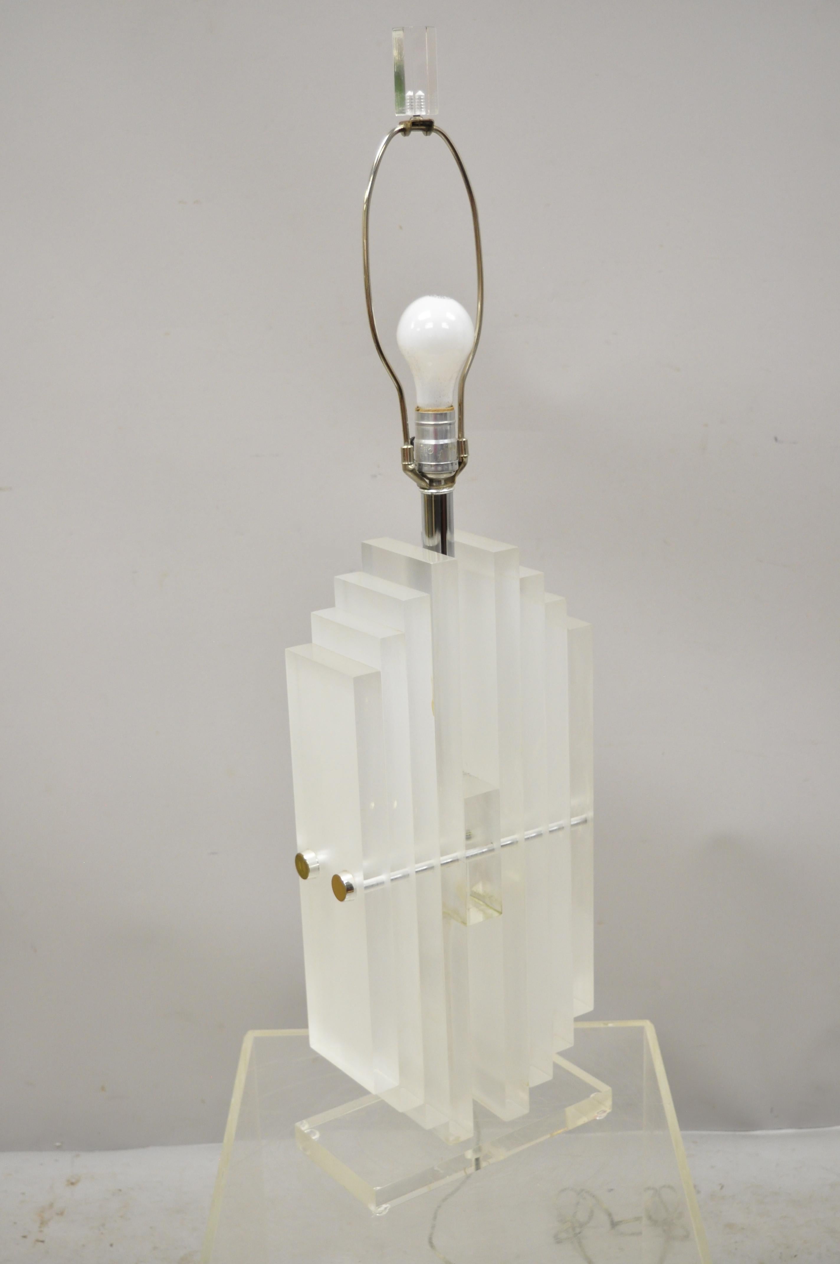 Vintage Mid-Century Modern heavy stacked Lucite Karl Springer style table lamp. Item features a chrome shaft, heavy stacked Lucite body, Lucite finial, very nice vintage item, clean modernist lines, quality American craftsmanship. Measurements: