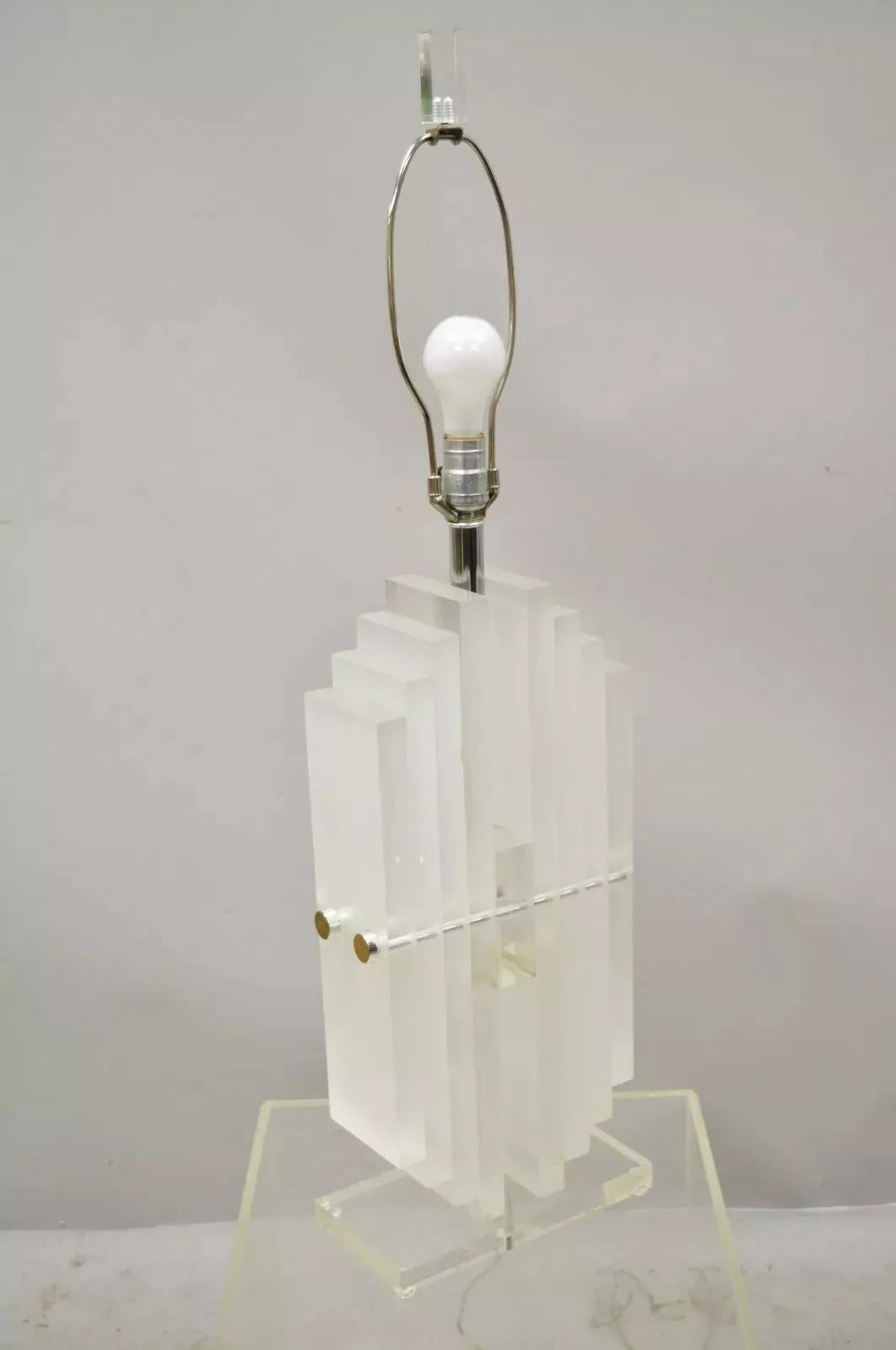 Vintage Mid Century Modern Heavy Stacked Lucite Skyscraper Table Lamp. Item features a chrome shaft, heavy stacked lucite body, lucite finial, very nice vintage item, clean modernist lines, quality American craftsmanship. Circa Mid 20th Century.
