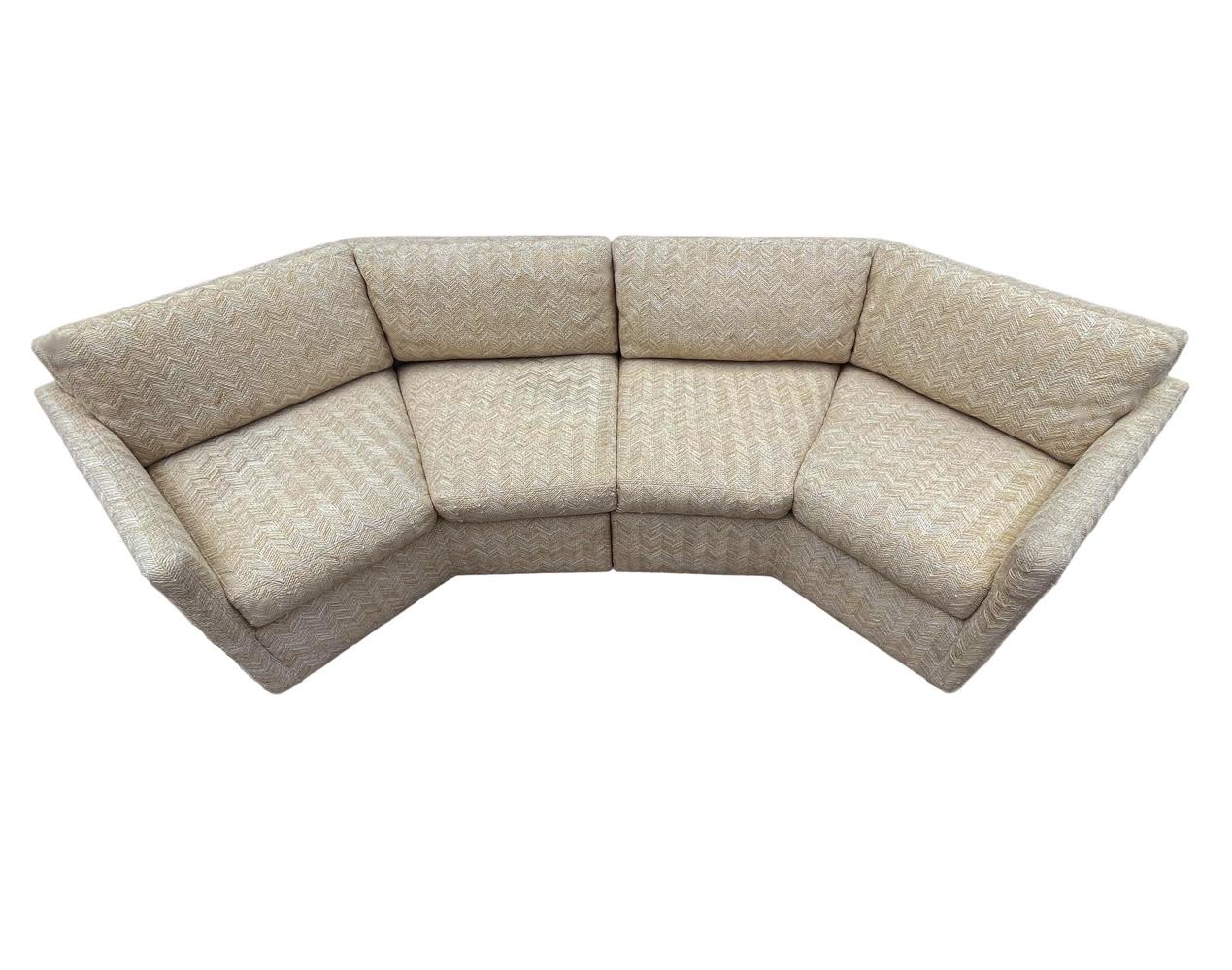 A sleek modern sofa in a hexagonal form circa 1970's. It features a two section design with low profile feet. Fabric is original and needs recovering. Foam and padding are fine. Seat depth measures 22.5 inches.