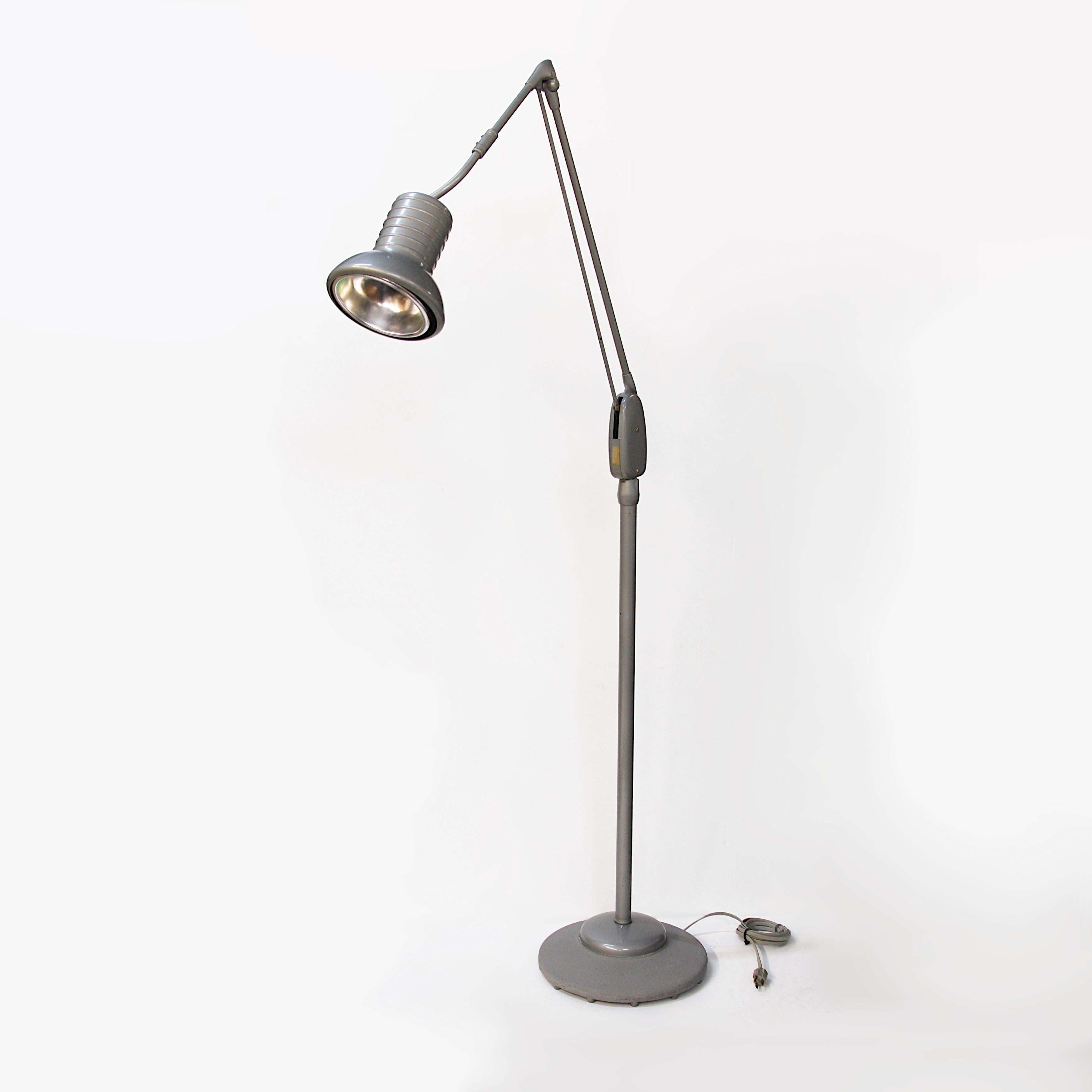 This lamp is a rare piece of Mid-Century Modern Industrial Design and features the hard-to-find, original gray/silver paint that really sets off the form beautifully. However, this lamp has function to match its form with a weighted base and