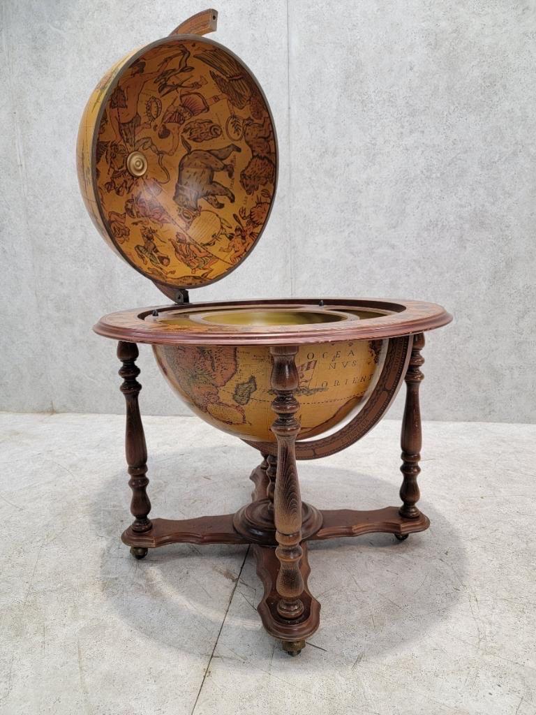 Vintage Mid Century Modern Italian Old World Zodiac Globe Cocktail Bar Cart on Turned Wood Leg Globe/Bar on Casters

Mid Century modern Italian hand-painted, floor standing globe enclosed in an intricate, hand-carved structure on casters. The globe