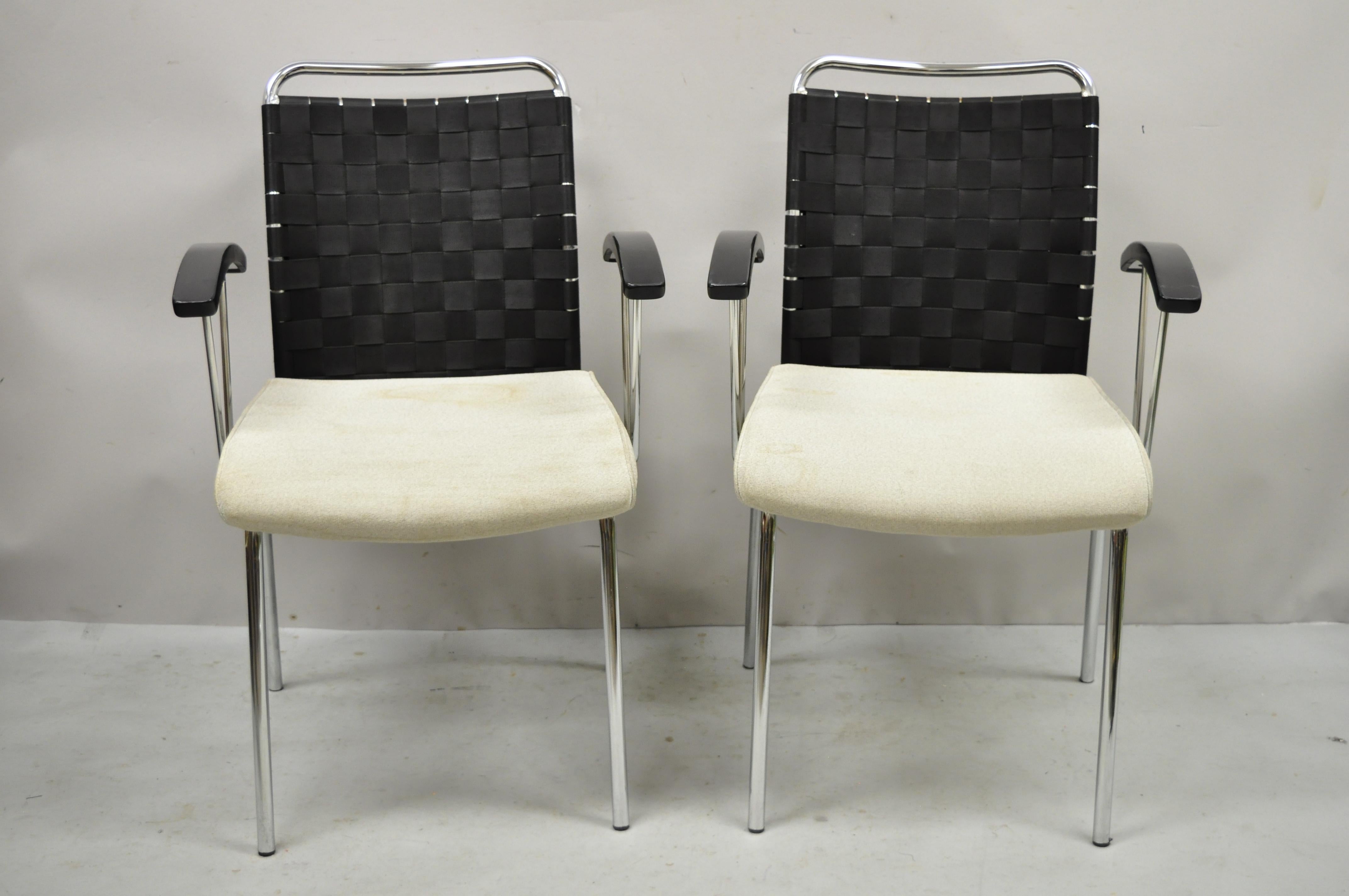 Vintage Mid Century Modern Italian Style woven back chrome frame arm chairs - a Pair. Item features woven fabric backs, solid wood armrests, upholstered seat, chrome metal steel frame, clean modernist lines, quality craftsmanship, great style and