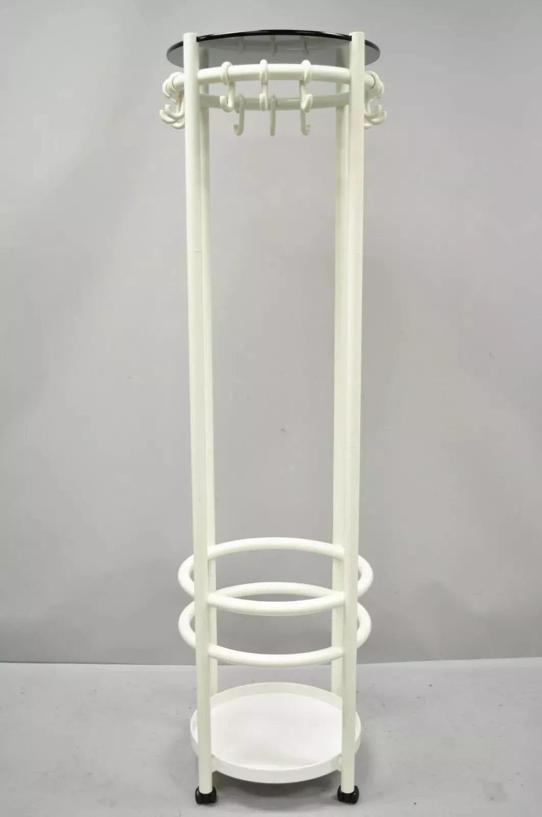Vintage Mid Century Modern Joe Colombo Style Coat Tree Stand. Item features a white coated plastic frame, 12 hooks, lower umbrella / cane stand holder, round smoked glass top, rolling casters, very nice vintage item, clean modernist lines, great