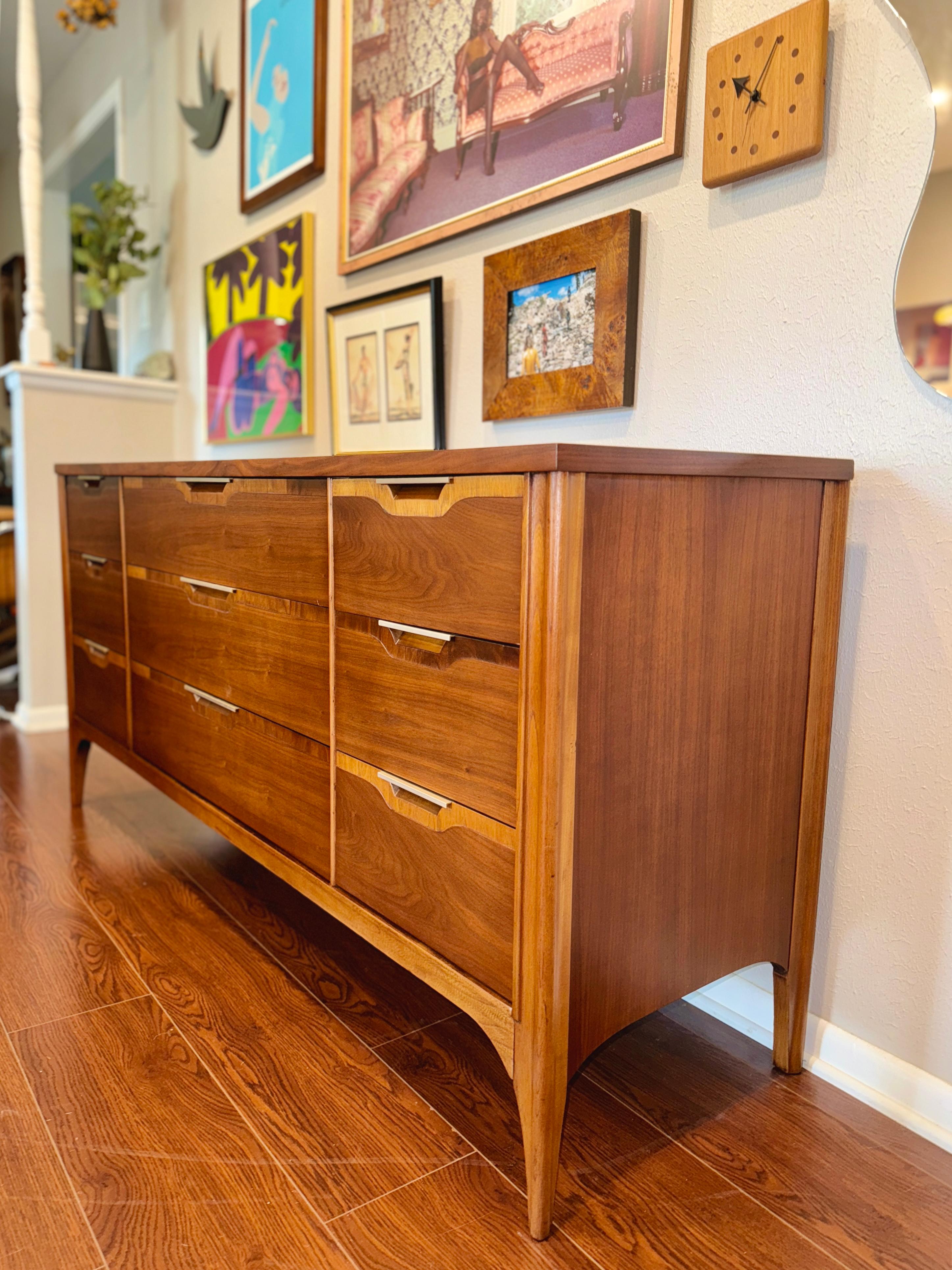 Vintage mid century modern Kent Coffey lowboy dresser and matching nightstand from the “impact” collection, circa 1960s. Recently fully refinished and in excellent condition. All drawers open and close smoothly. 

Dresser 64.5” W x 31” H x 18.5”