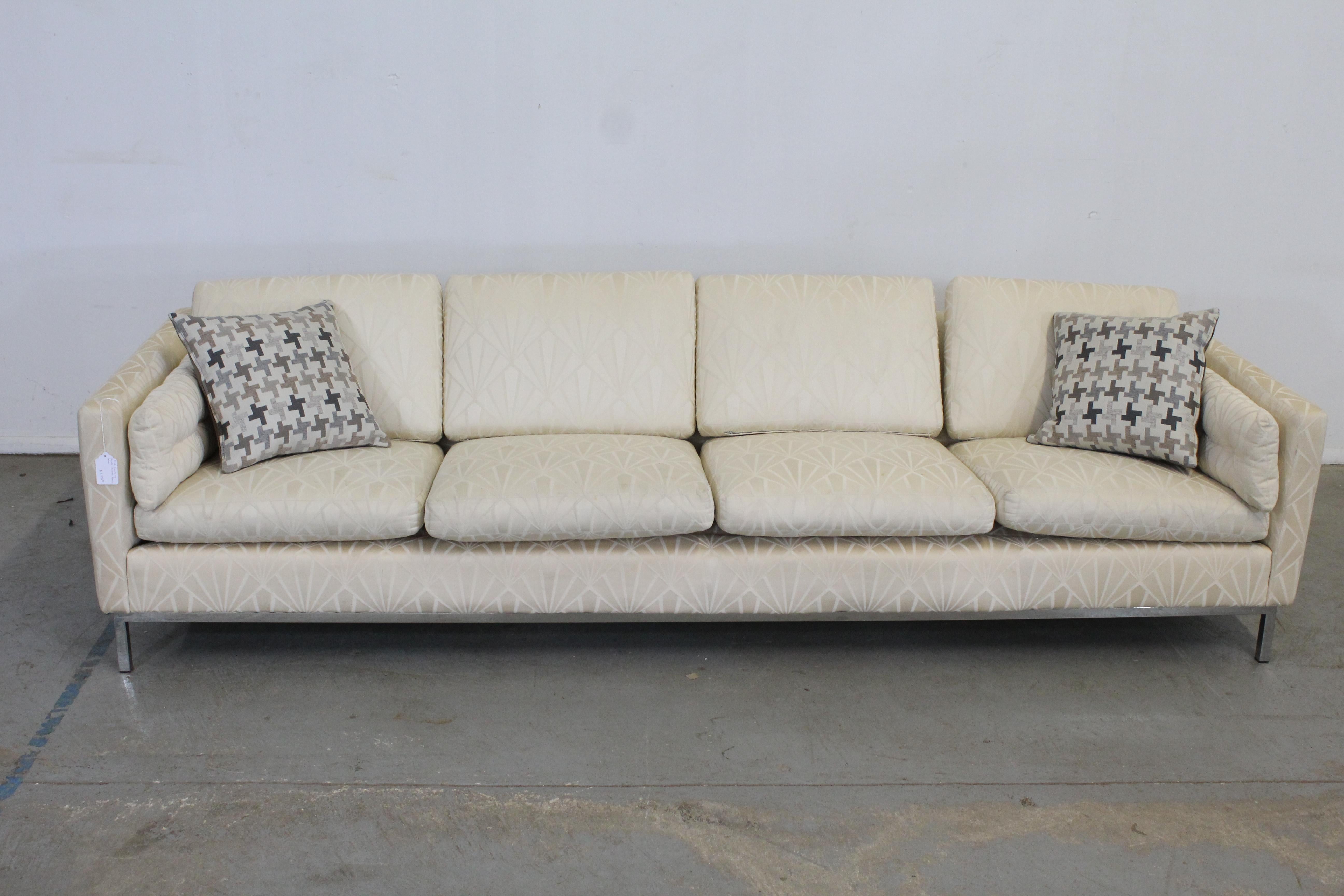 Offered is a vintage Mid-Century Modern sofa with textured upholstery and a chrome base attributed to Knoll. Has four removable seat and back cushions. It is in structurally sound condition, but needs to be reupholstered, showing stains on the