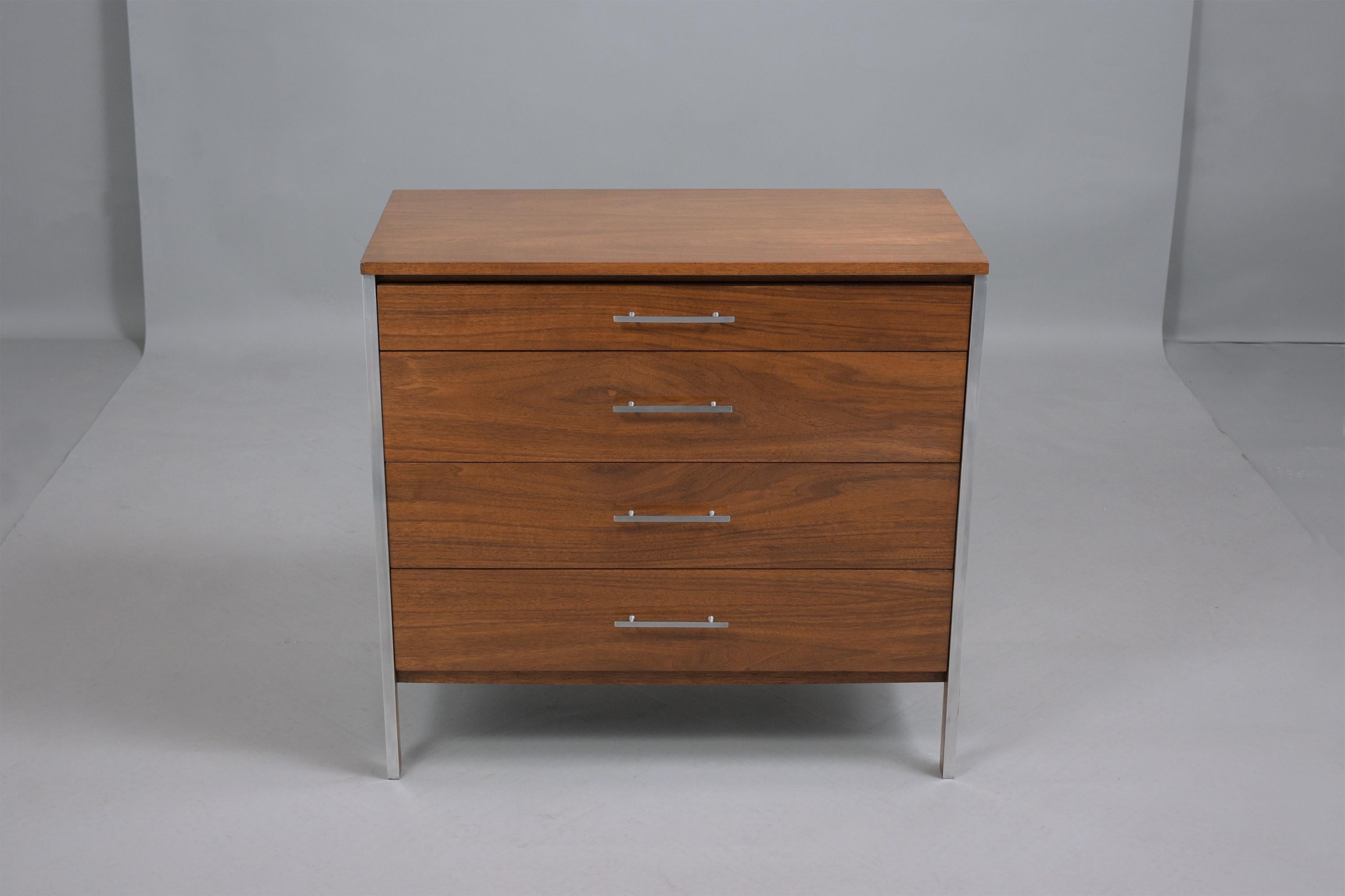 An extraordinary Mid-Century Modern chest of drawers by Paul McCobb for Calvin furniture has been fully restored by our team of expert craftsmen, is hand-crafted out of walnut wood, and is in great condition. This bachelor's chest has been newly