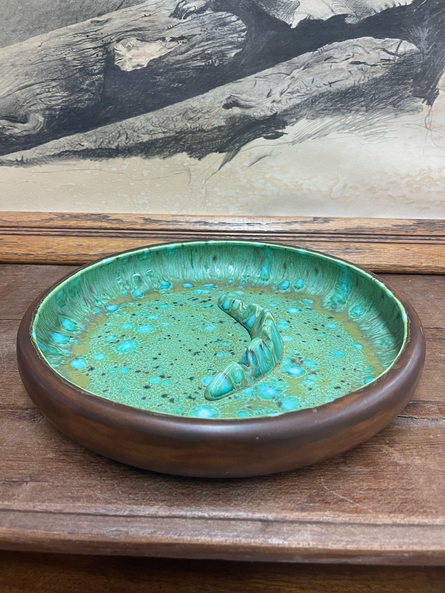 Ceramic Vintage Ash Tray with blue and green toned speckled interior Glaze. Brown color exterior. Circa 1970S. Vintage Condition Consistent with Age as Pictured

Dimensions. 11 Diameter; 2 H