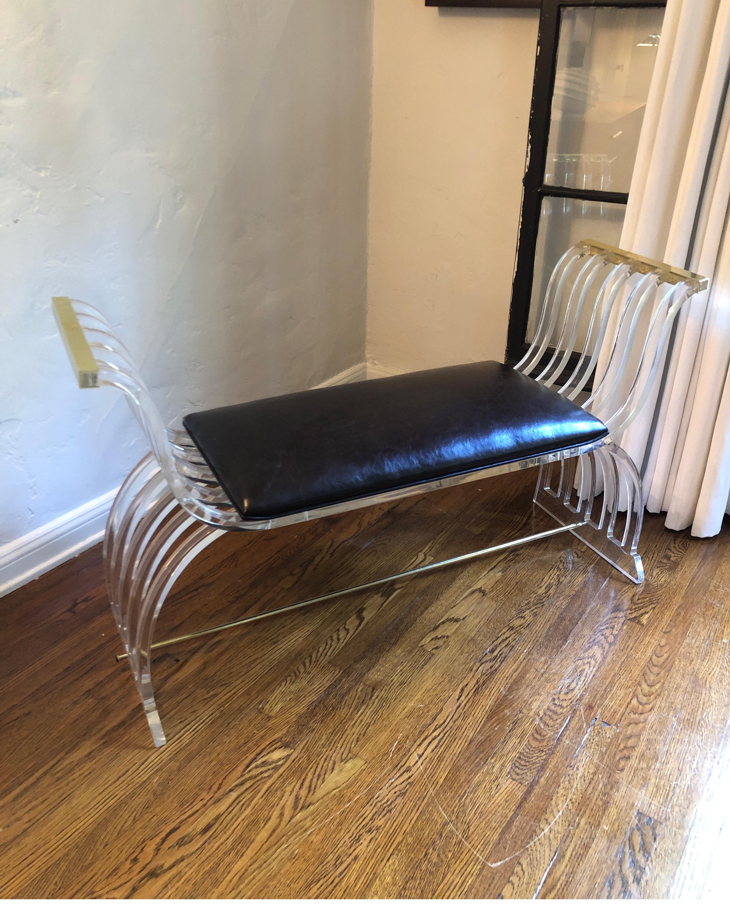 Vintage Lucite bench with leather seat and brass trim. Curved arms and legs.
Charless Hollis Jones style.
Leather seat easily removable for re-upholstering.