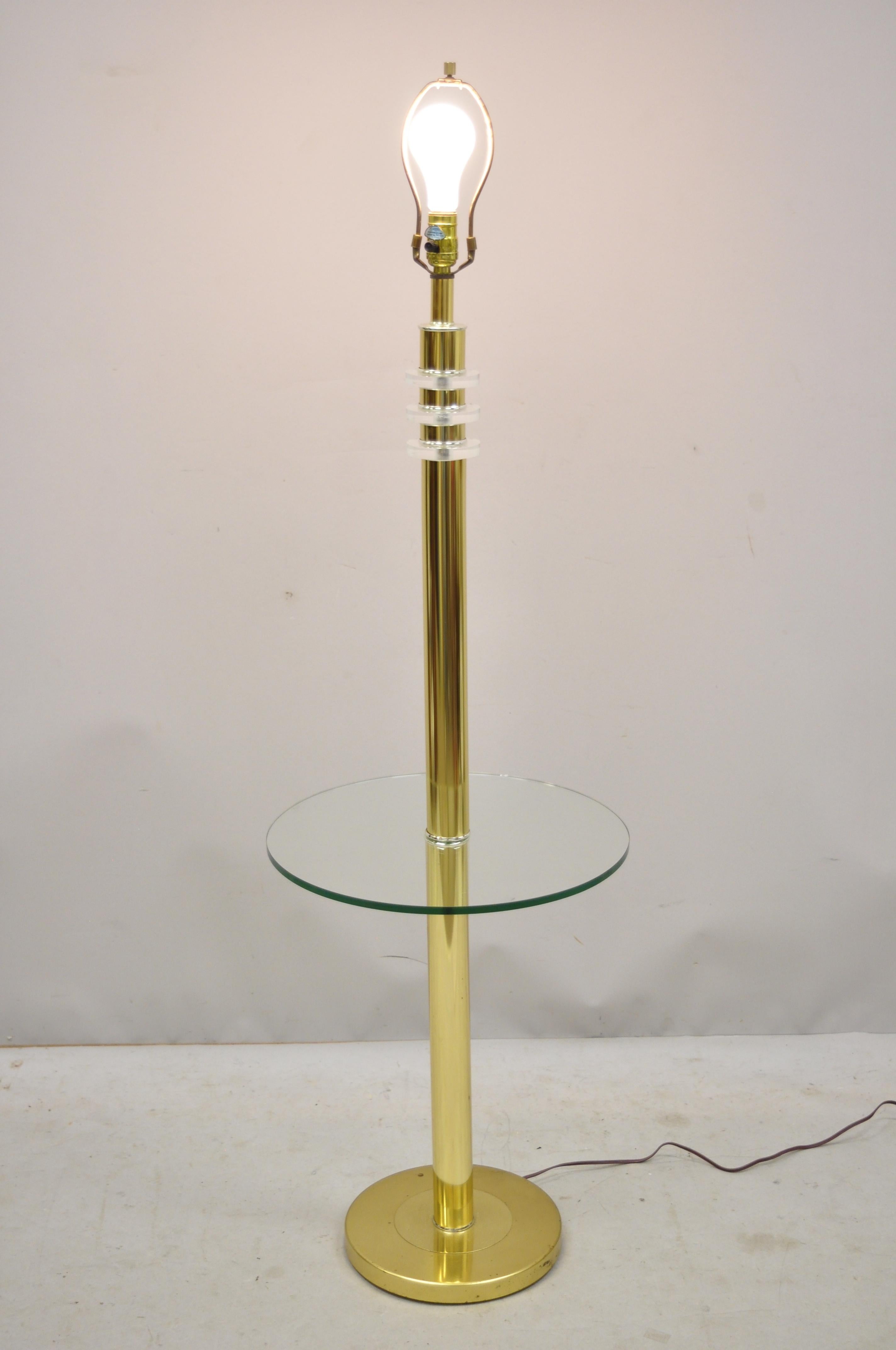 Vintage Mid-Century Modern Lucite brass glass pole floor lamp side table (B). Item features 3-way switch, Lucite accents, brass frame, round glass table top surface, clean Modernist lines, great style and form, circa mid-late 20th century.