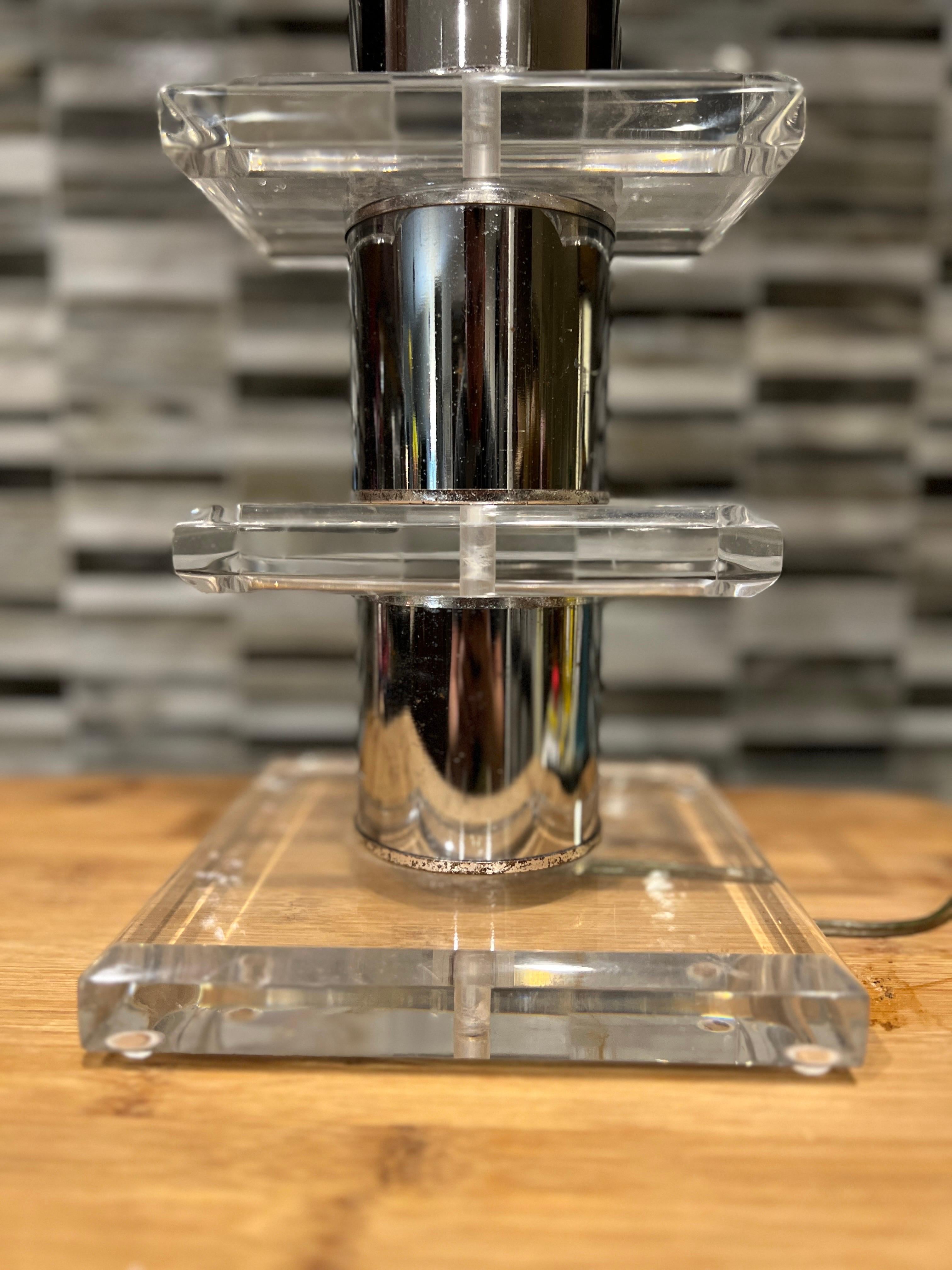 American, mid 20th century.

A vintage MCM table lamp with stacked and tiered lucite blocks separated by chrome cylinders. Apparently unmarked. 