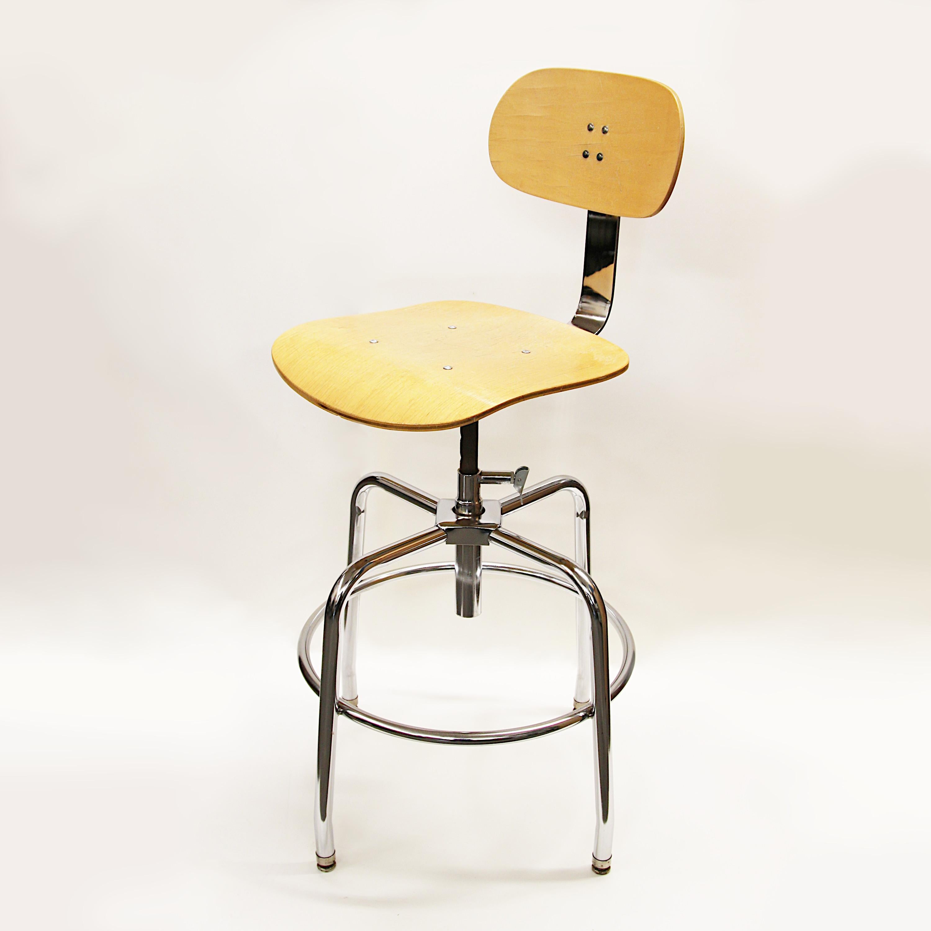Mid-century drafting stools by Garrett Tubular products. Stools feature height-adjustable bent-plywood backrest & seat, chrome tubular frame w/ footrest and a great industrial look! Seat height can be adjusted to 24, 26, or 28 inches high. Over 18