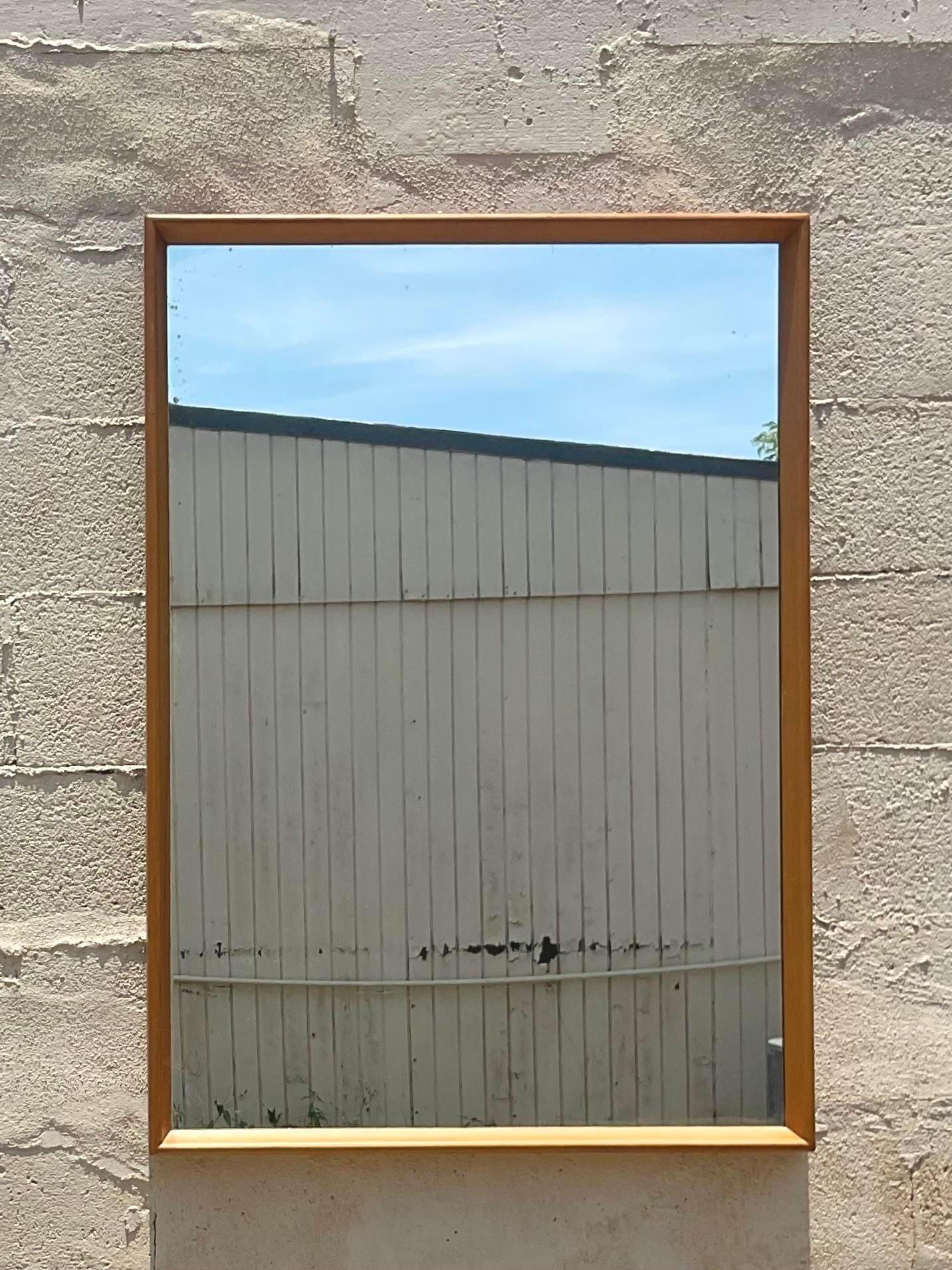 A fabulous vintage MCM wall mirror. Done in the manner of the iconic Heywood Wakefield group. A chic and simple design done in Maple wood. Acquired from a Palm Beach estate.