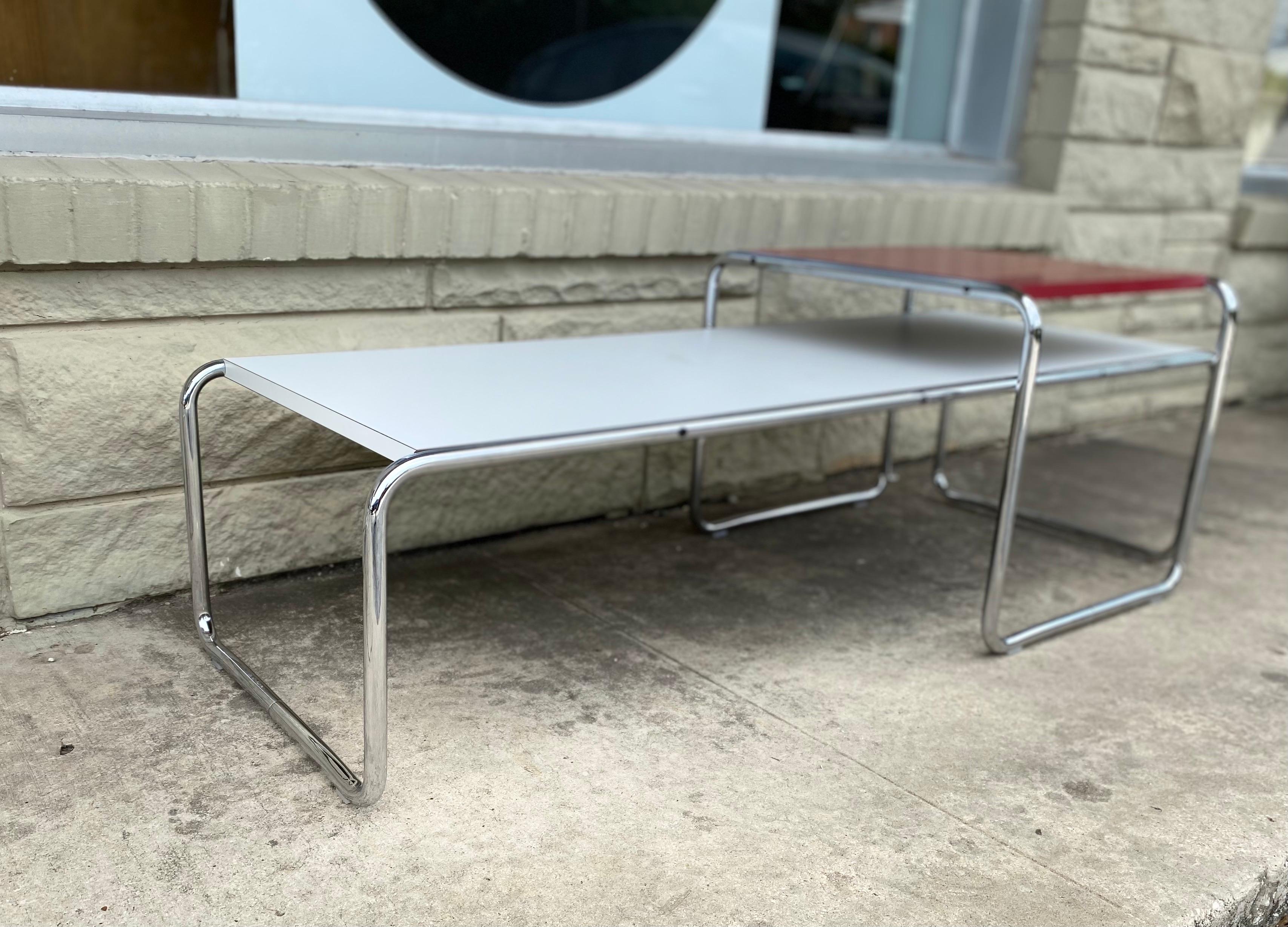 Mid-Century Modern Laccio coffee and side table designed by Marcel Breuer is functional and a unique piece for any space. Made of tubular steel and laminate top in satin finish, this coffee table and side table set is in good condition. 

side