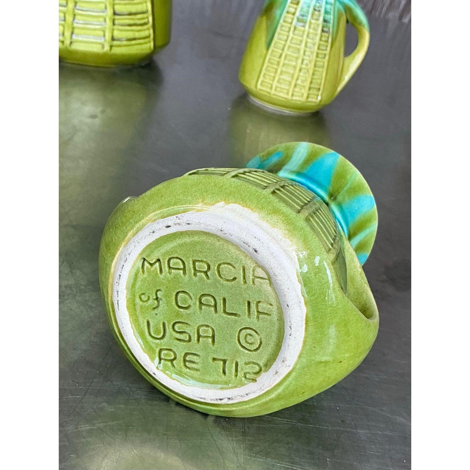 Infused with mid-century charm and California cool, this vintage glazed ceramic coffee service by Marcia of California is a vibrant three-piece set that blends function with collectible design. Showcasing a bold palette of citrus green and aqua