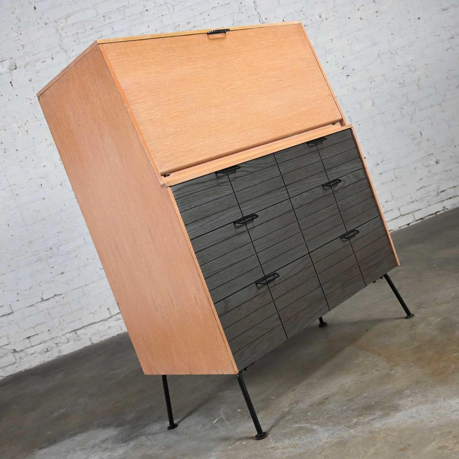Handsome vintage Mid-Century Modern Mengel drop front secretary desk by Raymond Loewy. Comprised of an oak case, cerused oak drawer fronts, and black iron hardware and legs. Beautiful condition, keeping in mind that this is vintage and not new so