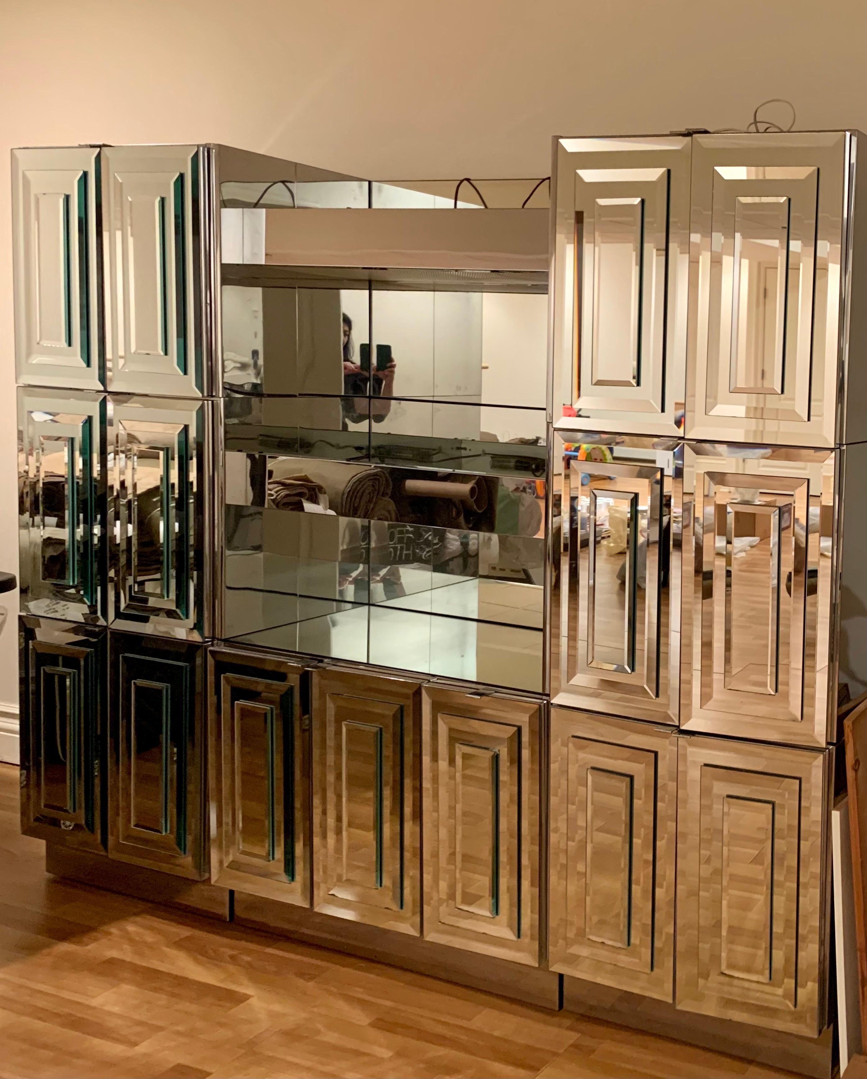Stunning Vintage Mid-Century Modern mirror glass sideboard by Ello Furniture. The coveted six door Skyscraper design features stacked folding door panels. They have lots of great storage space and the side panels are chrome metal. The center area