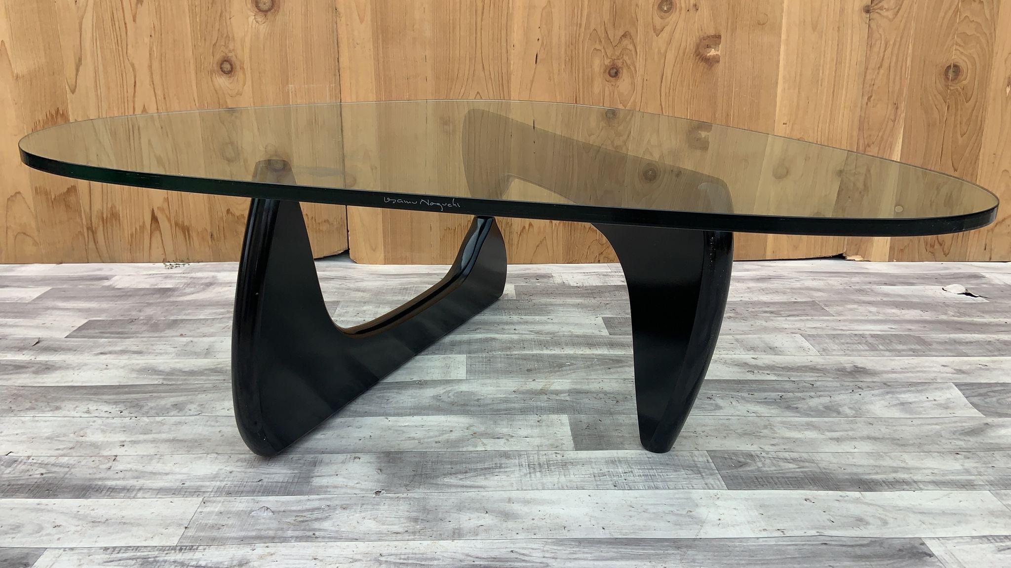 Vintage Mid Century Modern Noguchi Glass Top Coffee Table

This signed Isamu Noguchi Coffee table is a beautiful, simple design consists of only three elements, the glass top and two interlocking wood base pieces. This table was made by the