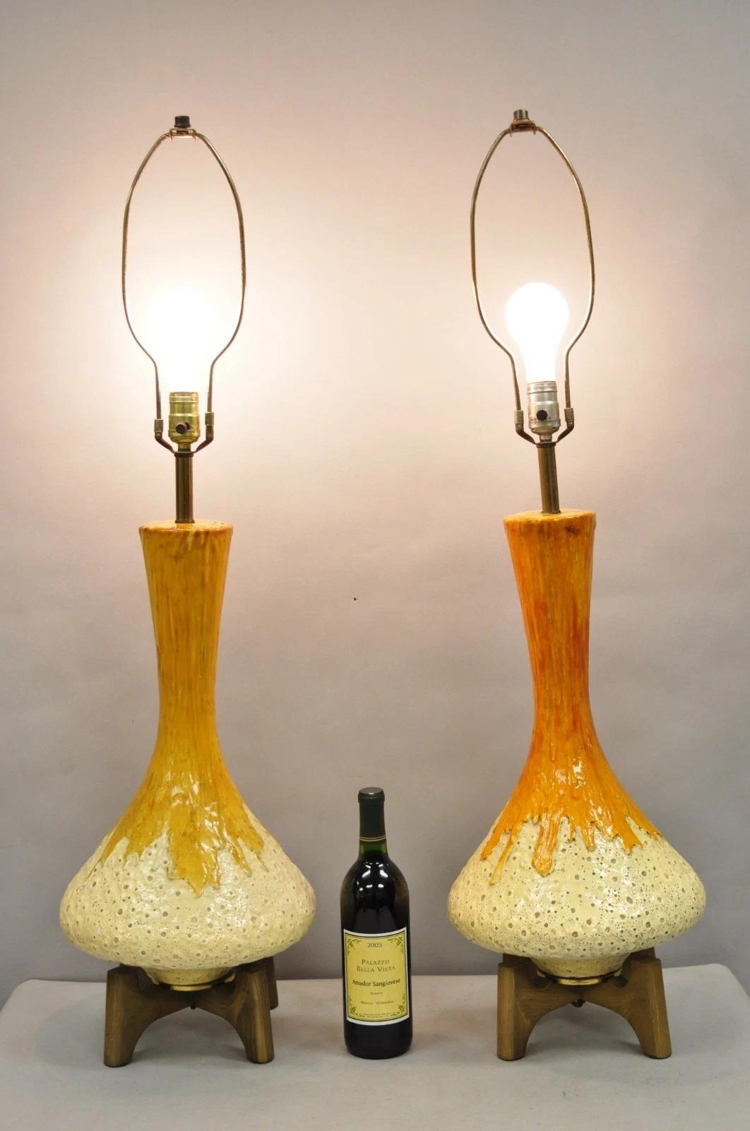 Vintage Mid Century Modern Orange Drip Glazed Ceramic Table Lamps on Sculpted Wood Bases - a Pair. Circa Mid 20th Century. Measurements: 40