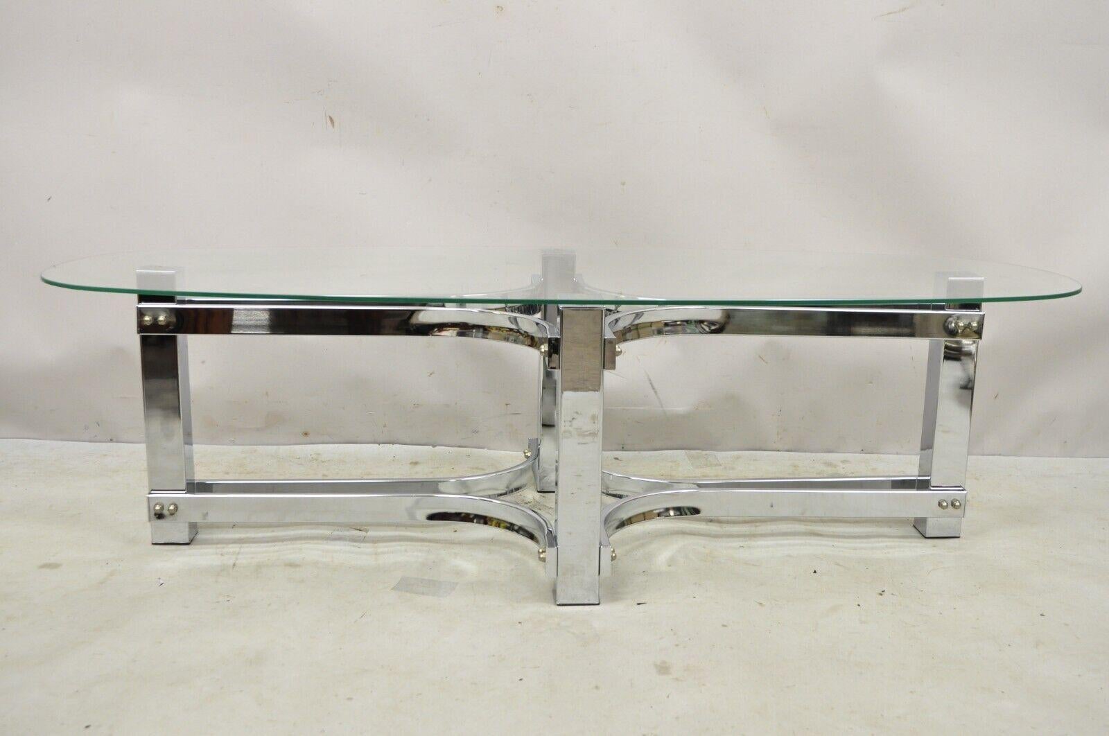Vintage Mid Century Modern Oval Glass Top Sculptural Chrome Frame Coffee Table. Item features an oval glass top, sculptural chrome pedestal base, very nice vintage item, great style and form. Circa Late 20th Century. Measurements: 14.5