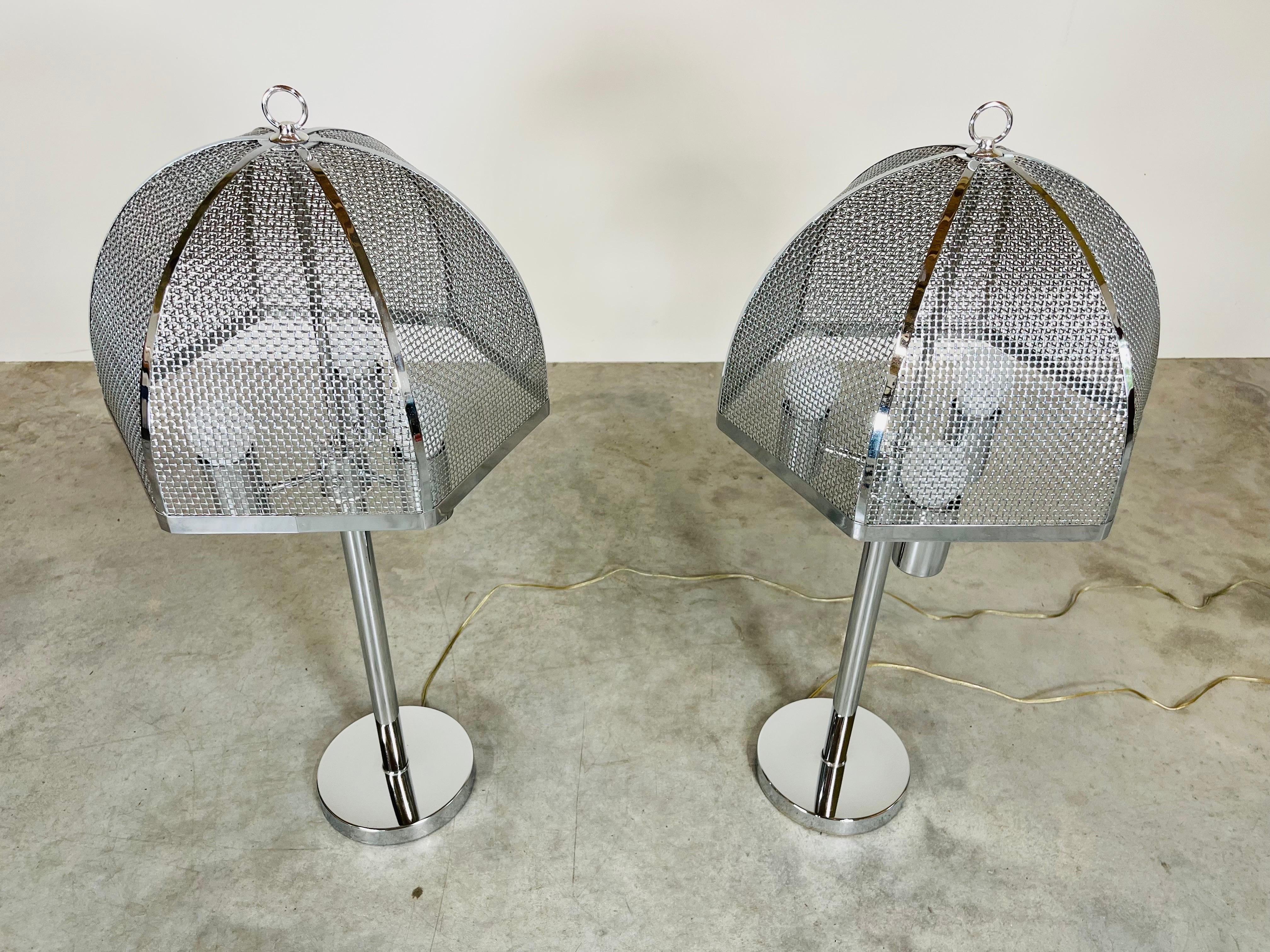 A striking pair of chromed steel table lamps in the manner of Laurel Lamp Company having chrome mesh shades. 
 In outstanding vintage condition having new wiring and phenomenal finish. No scratches or damage to report. These are as if they came out