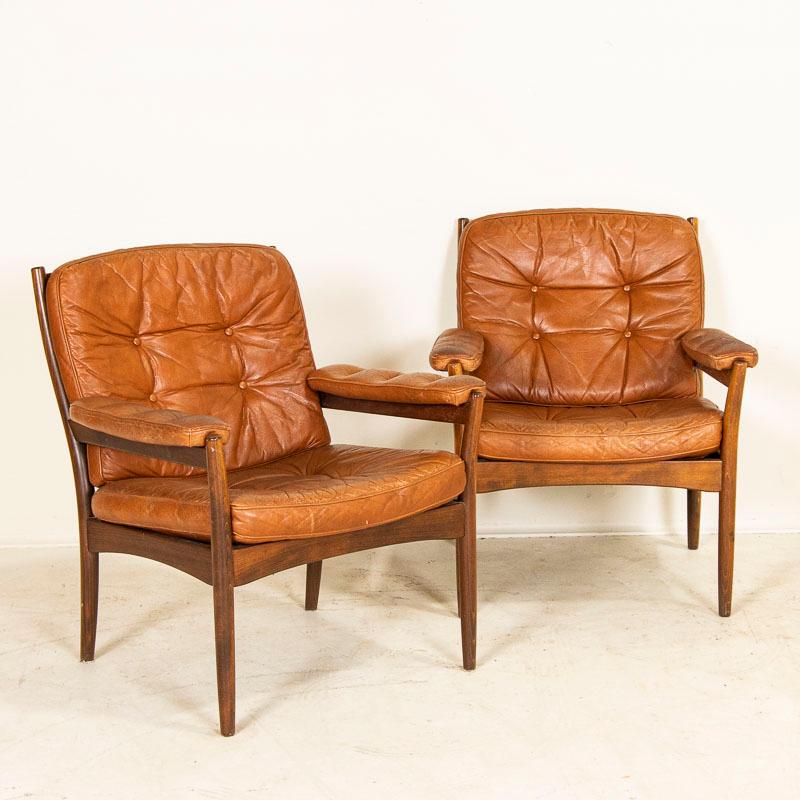 Pair of Göte Möbel stained beach armchairs with original leather. Great pair of Mid-Century Modern chairs to fit in today's modern home. Please refer to photos to appreciate the vintage wear of the leather, including creases, crackling, etc. which