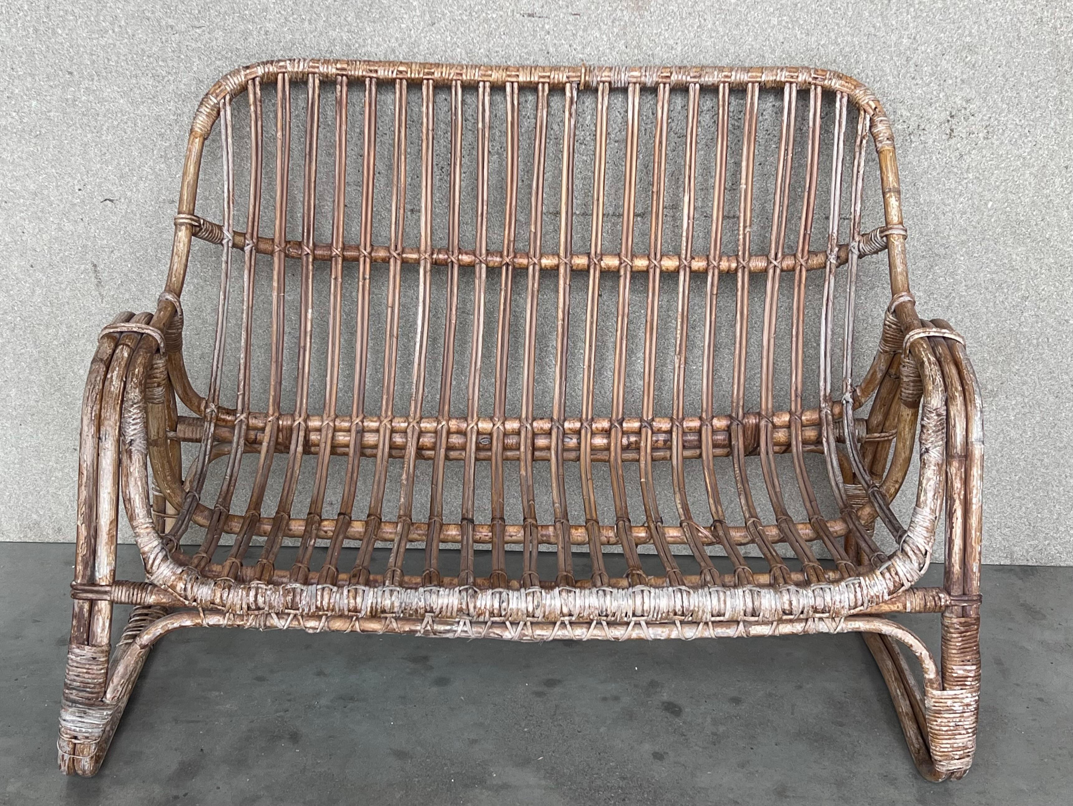 Nicely shaped rattan and bamboo frame. This wonderful Vintage Mid-Century Modern love seat or sofa is in very good condition with minor wear consistent with age and use, preserving a beautiful patina. This lovely piece of furniture looks wonderful