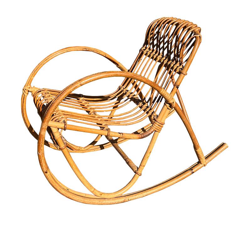 Discover the charm and nostalgia of mid-century design with this vintage French rattan children’s rocking chair, dating to the 1950s. Handcrafted with gracefully curved bentwood and tightly bound rattan weaving, this petite rocker exudes warmth,