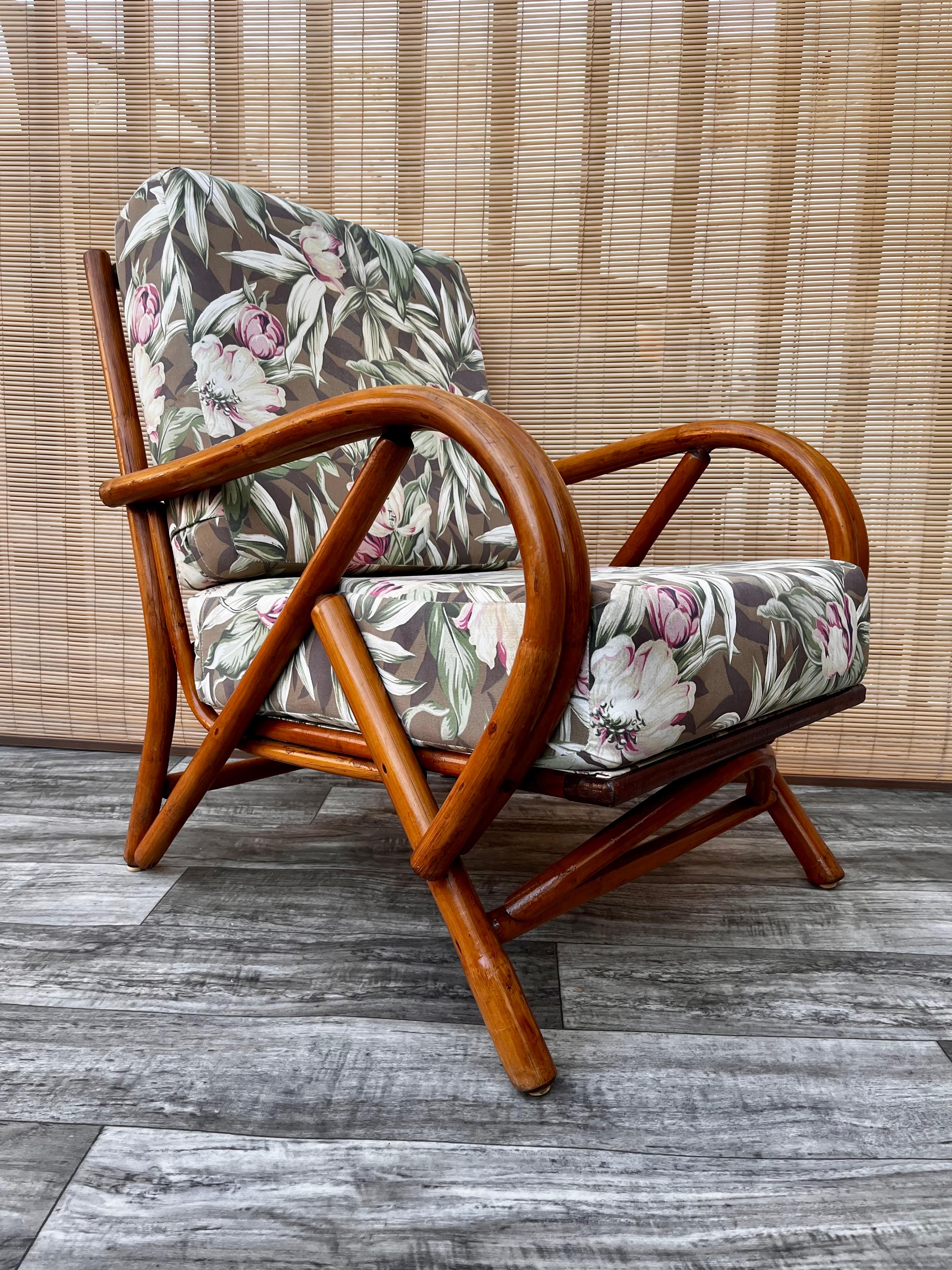 Vintage Mid-Century Modern Rattan lounge chair, circa 1960s
Feature a rattan frame and bent rattan armrests with removable seating and backrest cushions, upholstered in floral motive fabric.
In good sound and cosmetic condition with signs of wear