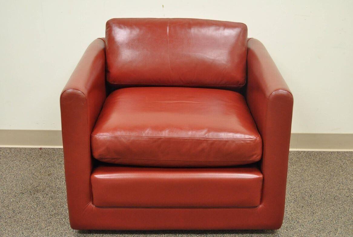 Vintage Mid-Century Modern red leather cube club lounge chair on casters. Item features quality vintage, post Mid-Century Modern, cube form club chair in red leather on rolling casters. The chair features clean lines, comfortable form, solid frame,