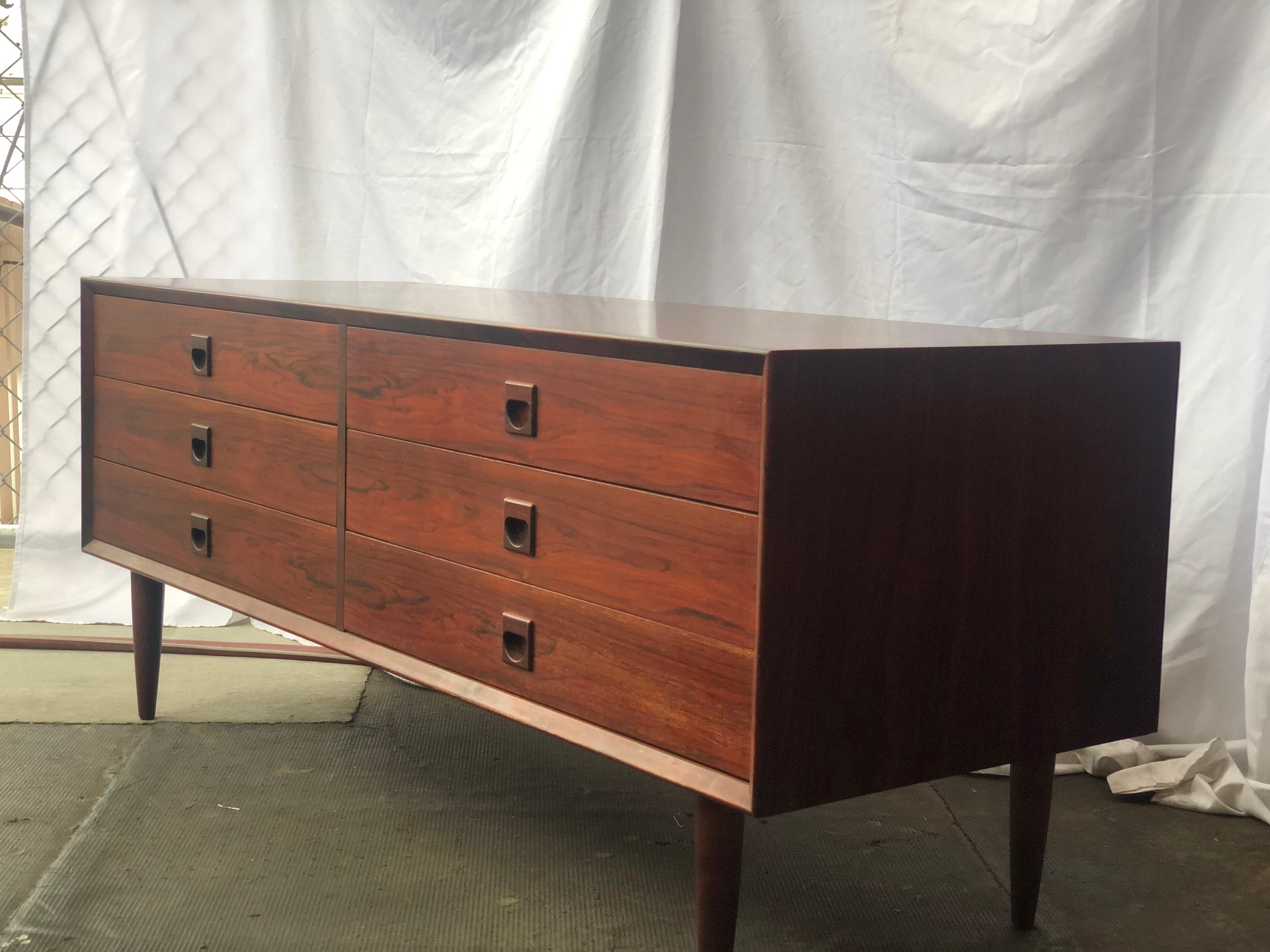 Beautiful short, dark rosewood sideboard with lovely wide drawers and square, inset handles. Good vintage condition.