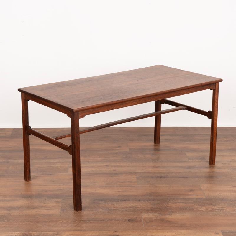 Crafted by a Danish master carpenter, this clean-lined, mid-century rosewood coffee table has both solid and veneered rosewood. Please review close up photos to appreciate the  attractive wood and joints. Any typical nicks, scratches, scuffs are