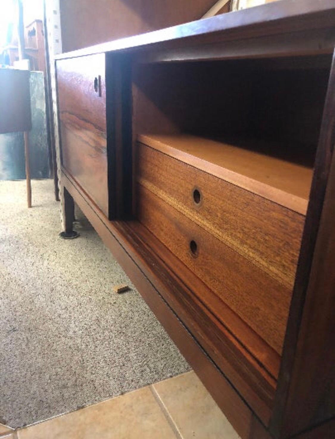 A functional Danish rosewood cabinet credenza. Accessed by two sliding doors the interior is divided into two compartments. The compartments are sized to hold records or any other media items.
